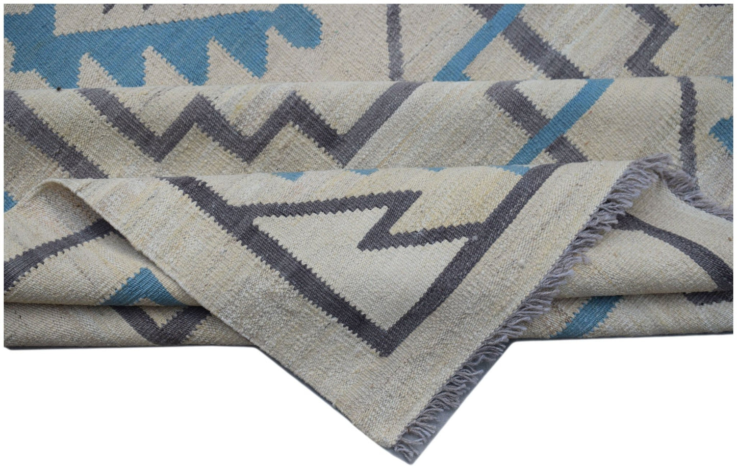 Handwoven Afghan Maimana kilim rug featuring a geometric pattern in blue, grey, and cream wool.