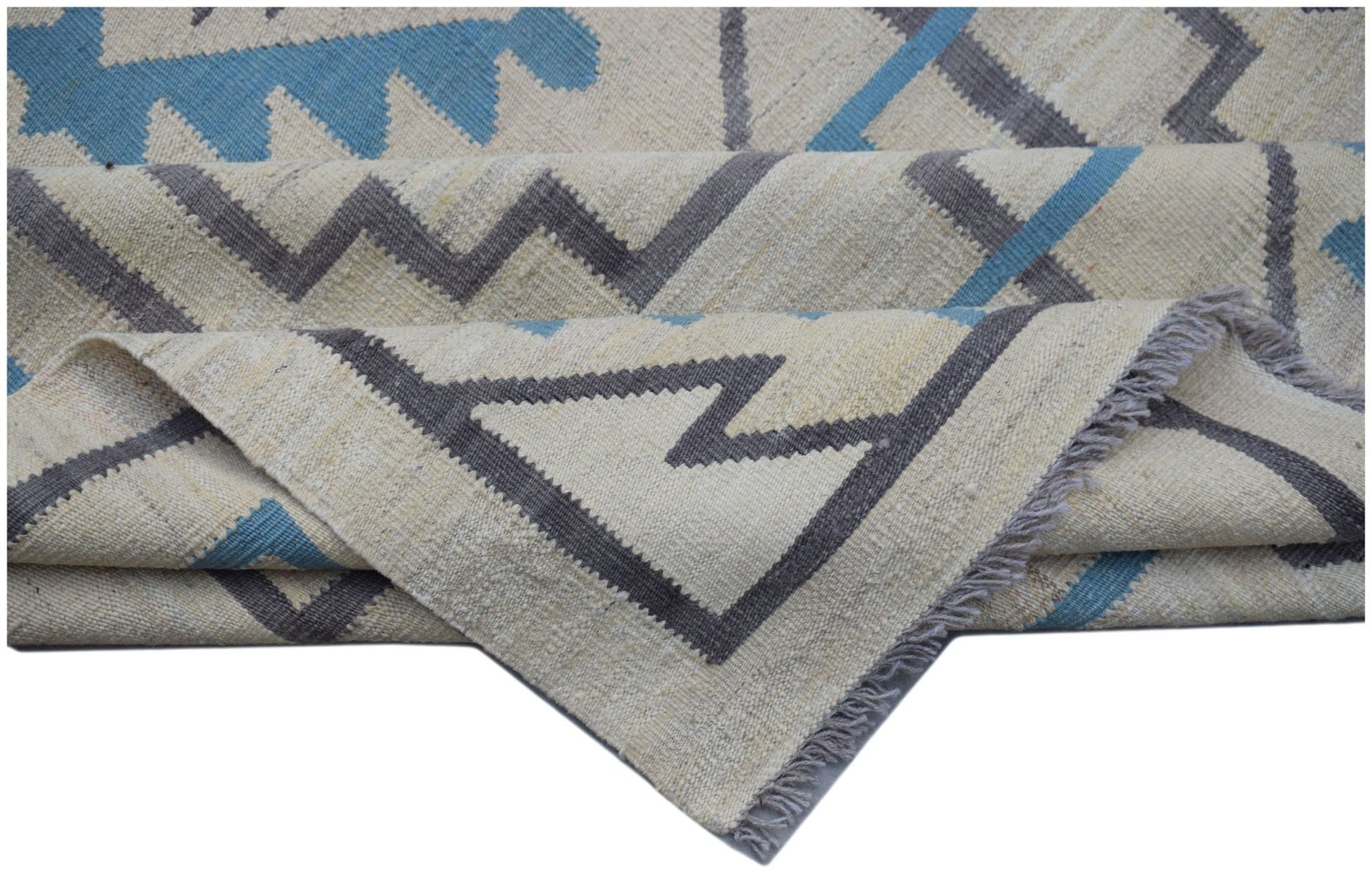 Handwoven Afghan Maimana kilim rug featuring a geometric pattern in blue, grey, and cream wool.
