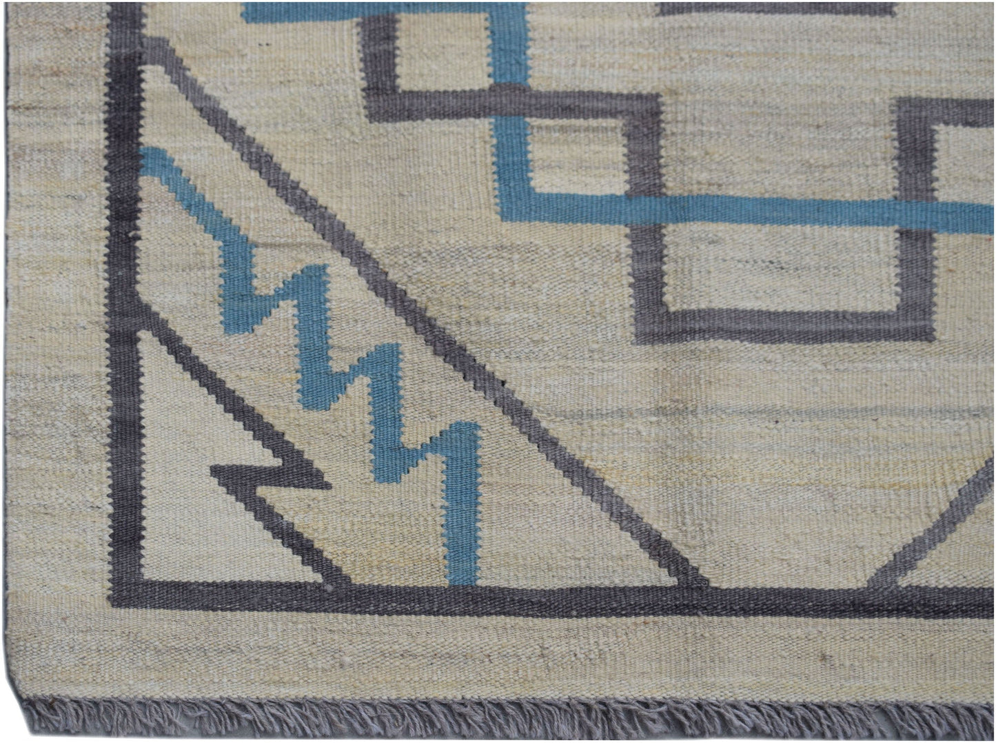 Handwoven Afghan Maimana kilim rug featuring a geometric pattern in grey and blue on a cream base.