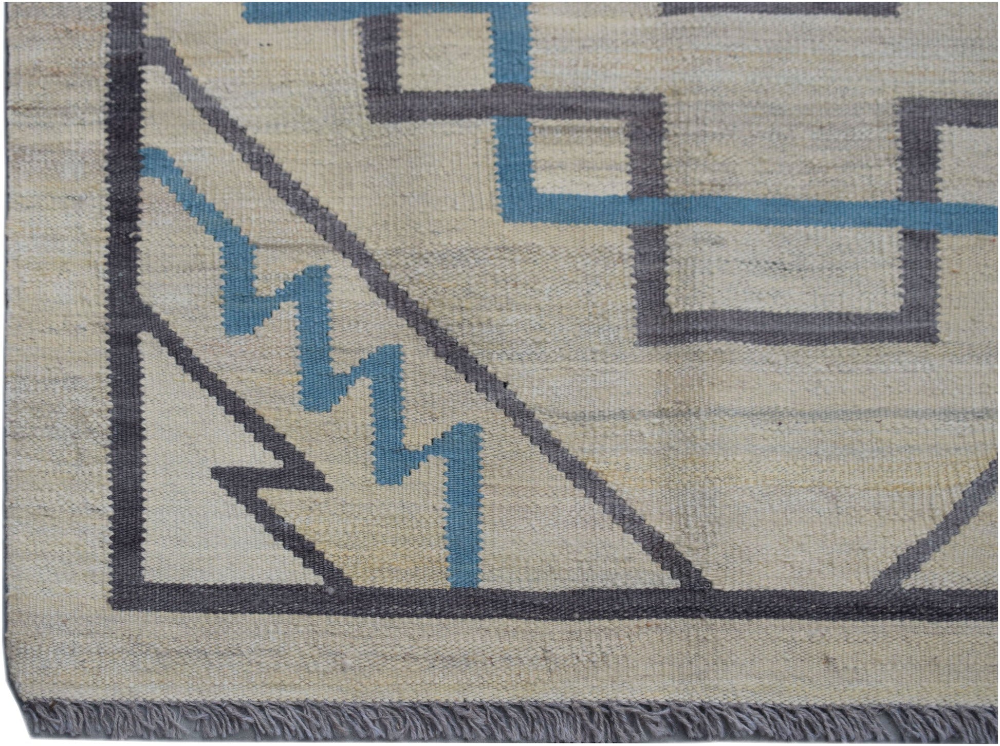 Handwoven Afghan Maimana kilim rug featuring a geometric pattern in grey and blue on a cream base.