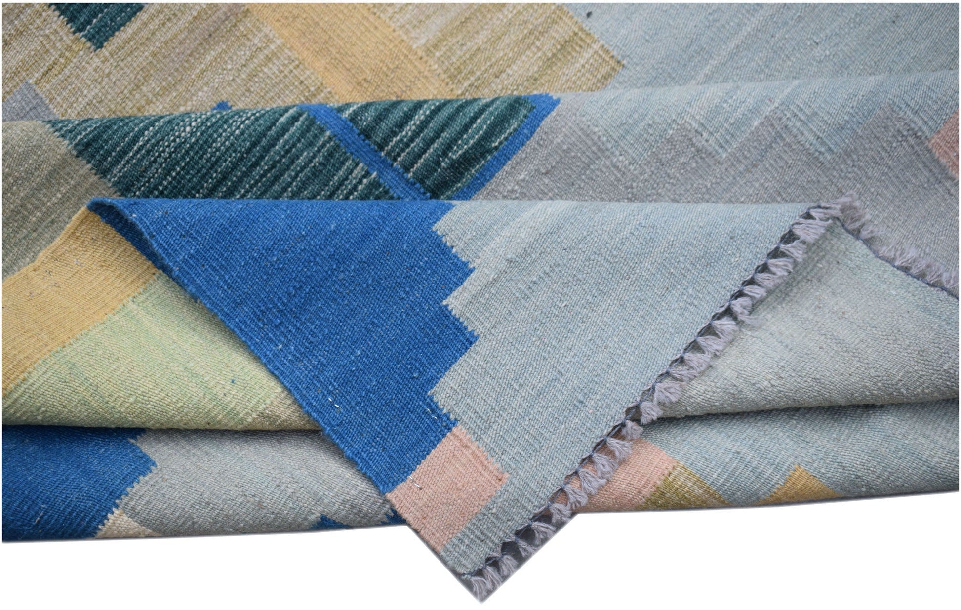 A handmade Afghan Maimana kilim rug featuring a geometric pattern in blue, yellow, and grey tones.