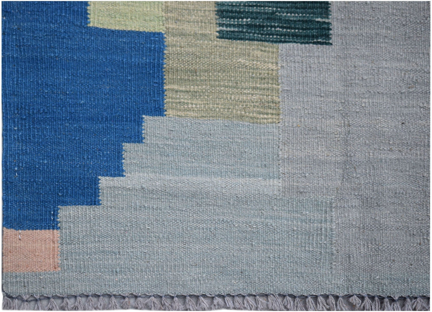 Handwoven Afghan Maimana kilim rug featuring a geometric pattern in blue, grey, and green tones.