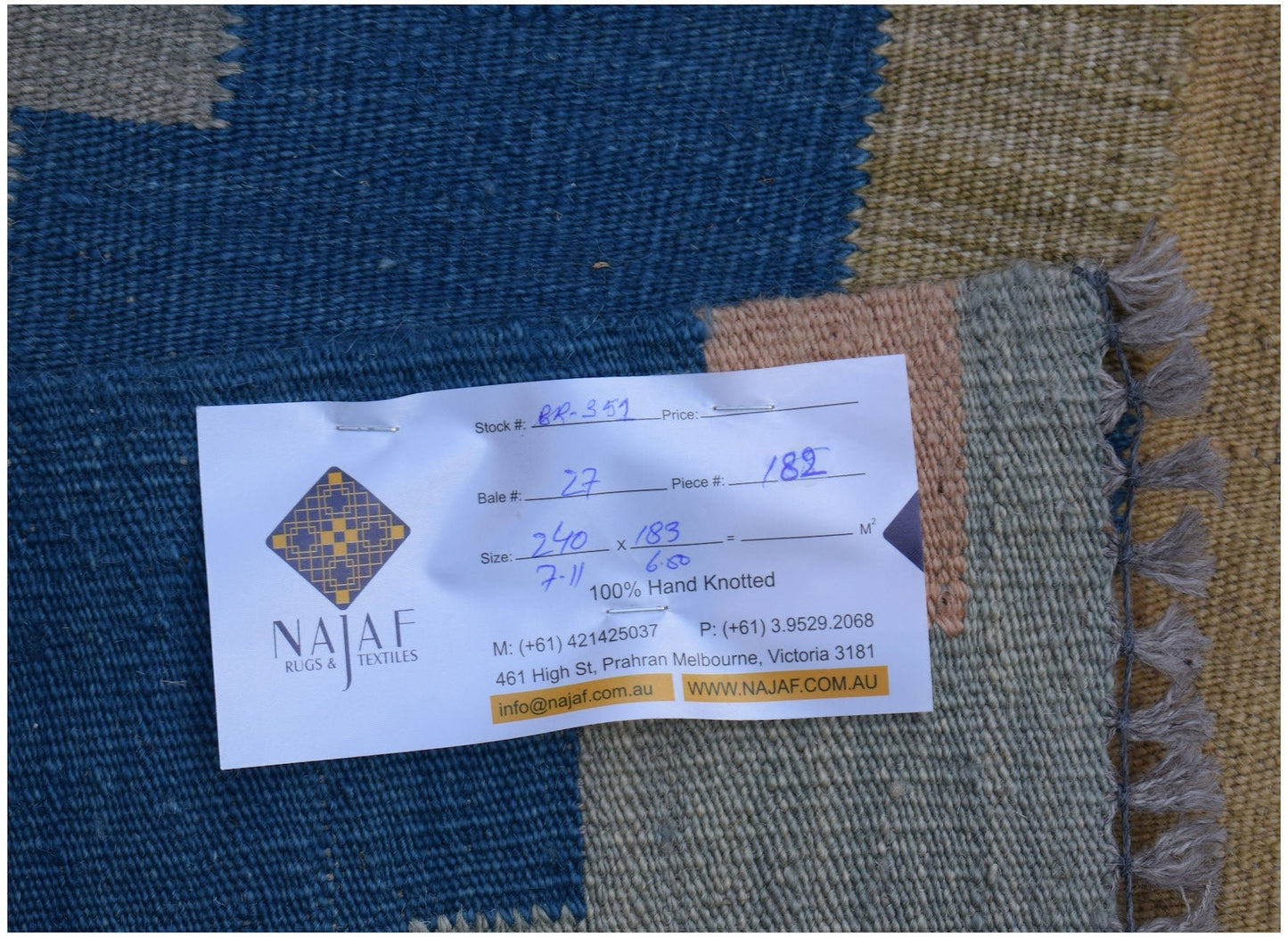 A handwoven Afghan Maimana kilim featuring a geometric pattern in blue, tan, and grey tones.