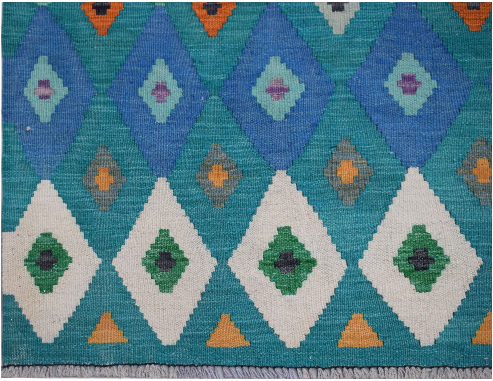 Handwoven Afghan Maimana kilim rug featuring a geometric diamond pattern in blue, green, and white.