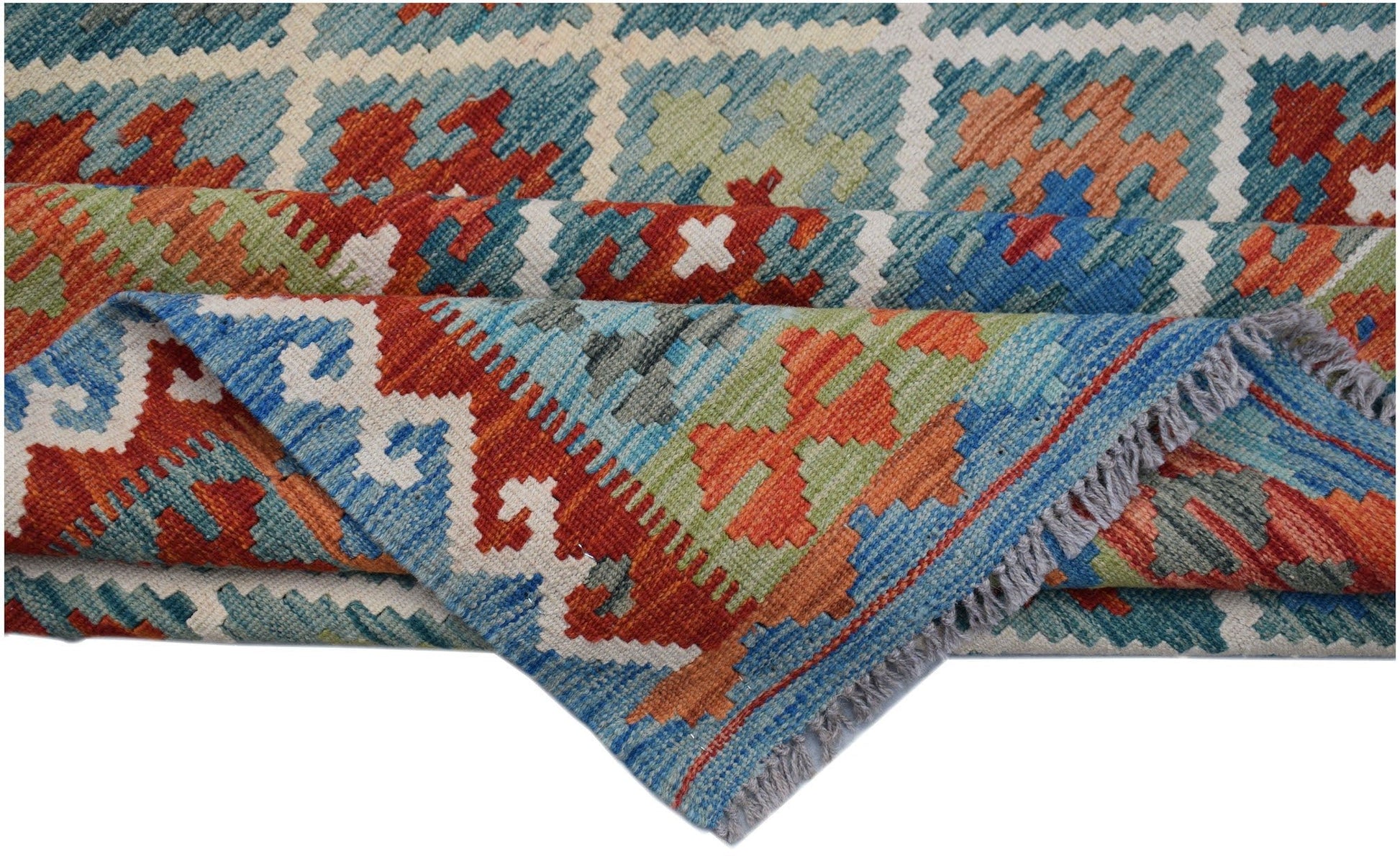 A handwoven Afghan Maimana kilim rug featuring a geometric pattern in blue, orange, and green.