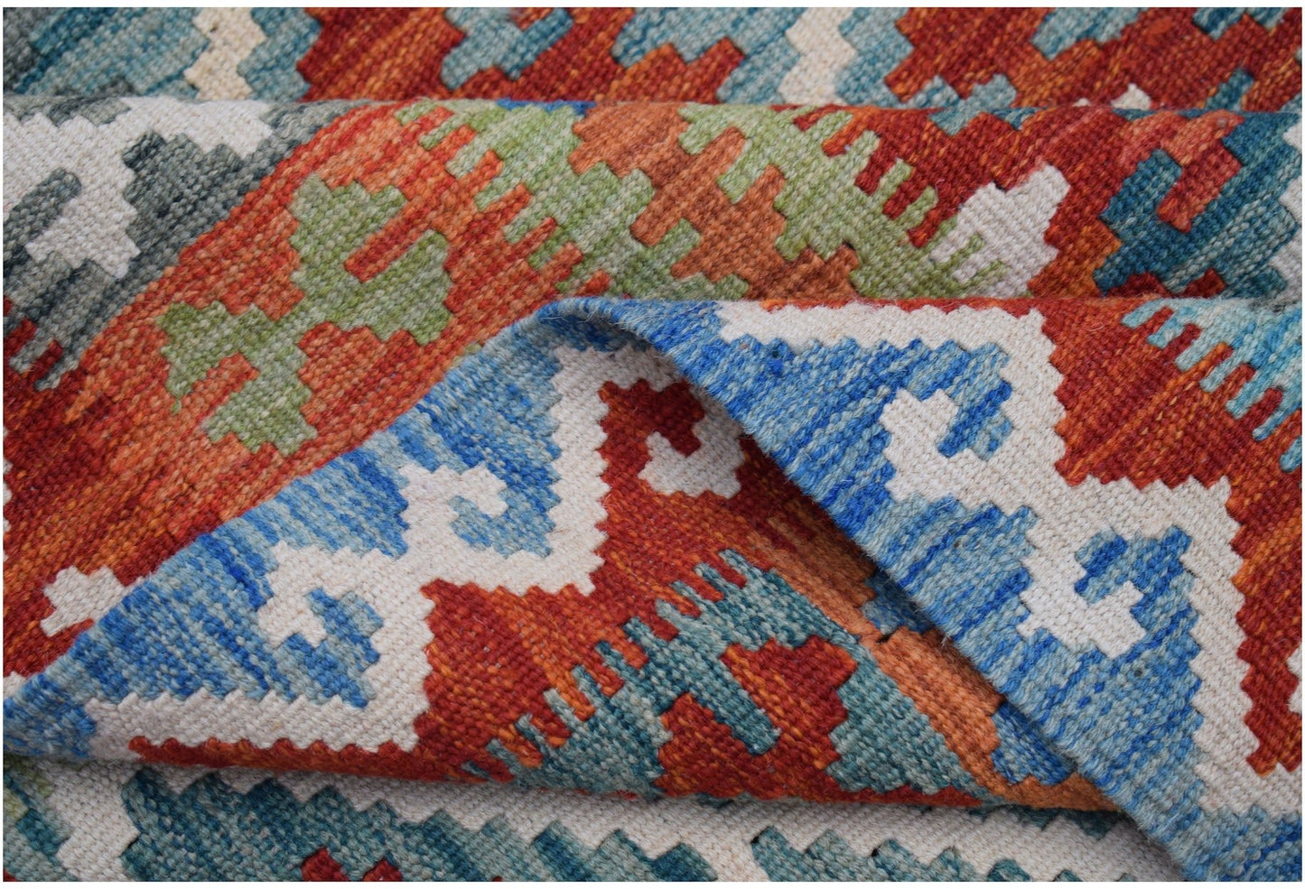 A handwoven Afghan Maimana kilim rug featuring a vibrant geometric pattern in wool.
