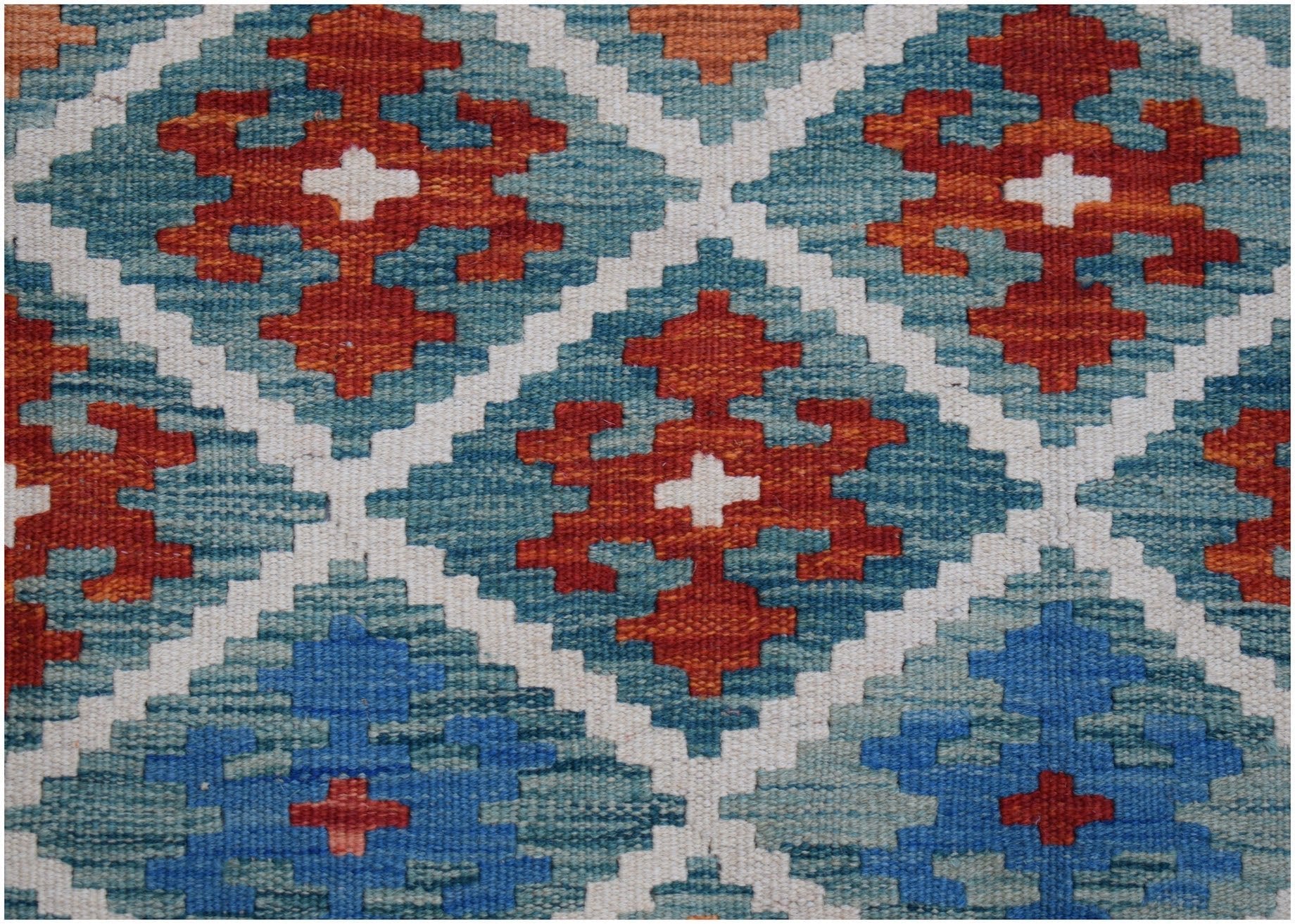 Handwoven Afghan Maimana kilim rug featuring a geometric diamond pattern in blue and orange tones.