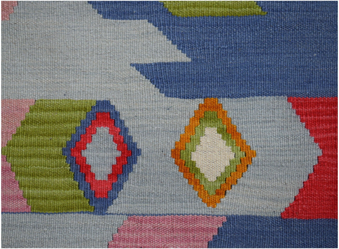 Handwoven Afghan Maimana kilim featuring a geometric pattern in vibrant blue, red, and green tones.
