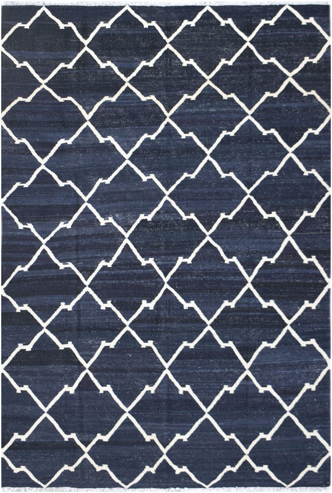 Handwoven Afghan Maimana kilim rug featuring a white geometric lattice pattern on a navy blue field.