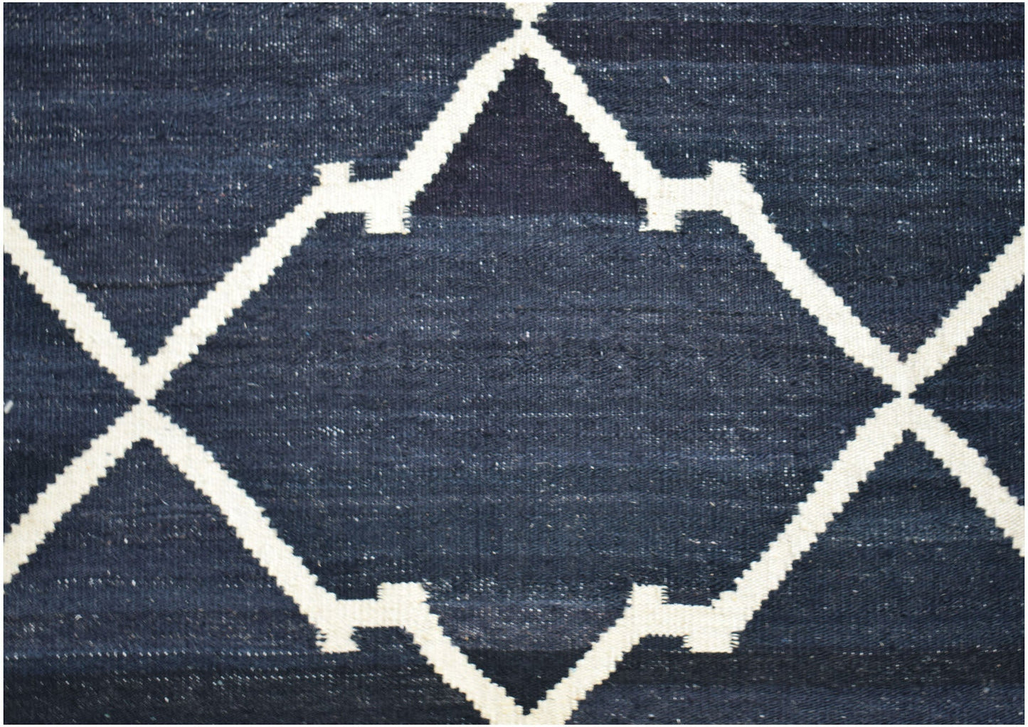 Handwoven Afghan Maimana kilim rug featuring a dark blue field with a white geometric lattice.