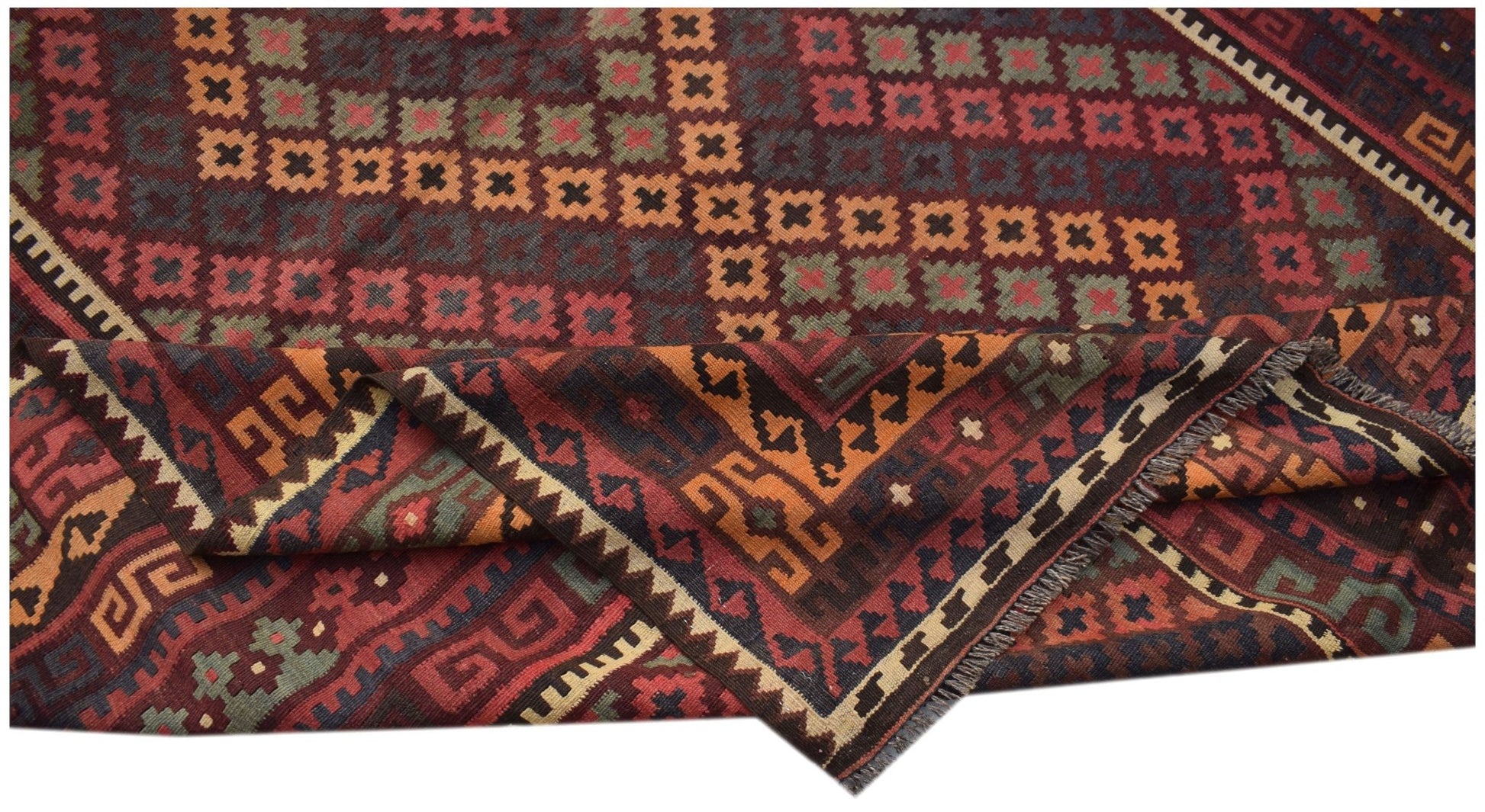 A handmade Afghan Maimana kilim rug featuring a geometric pattern in red, orange, and green wool.