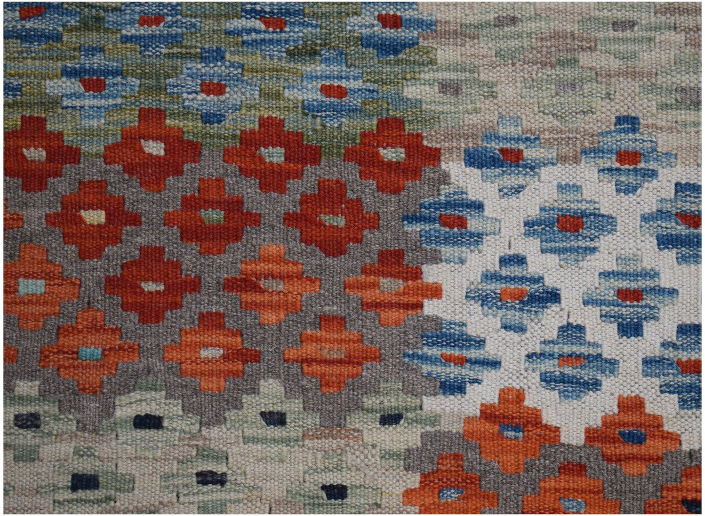Handwoven Afghan Maimana kilim rug featuring a geometric pattern in vibrant, multicolored tones.