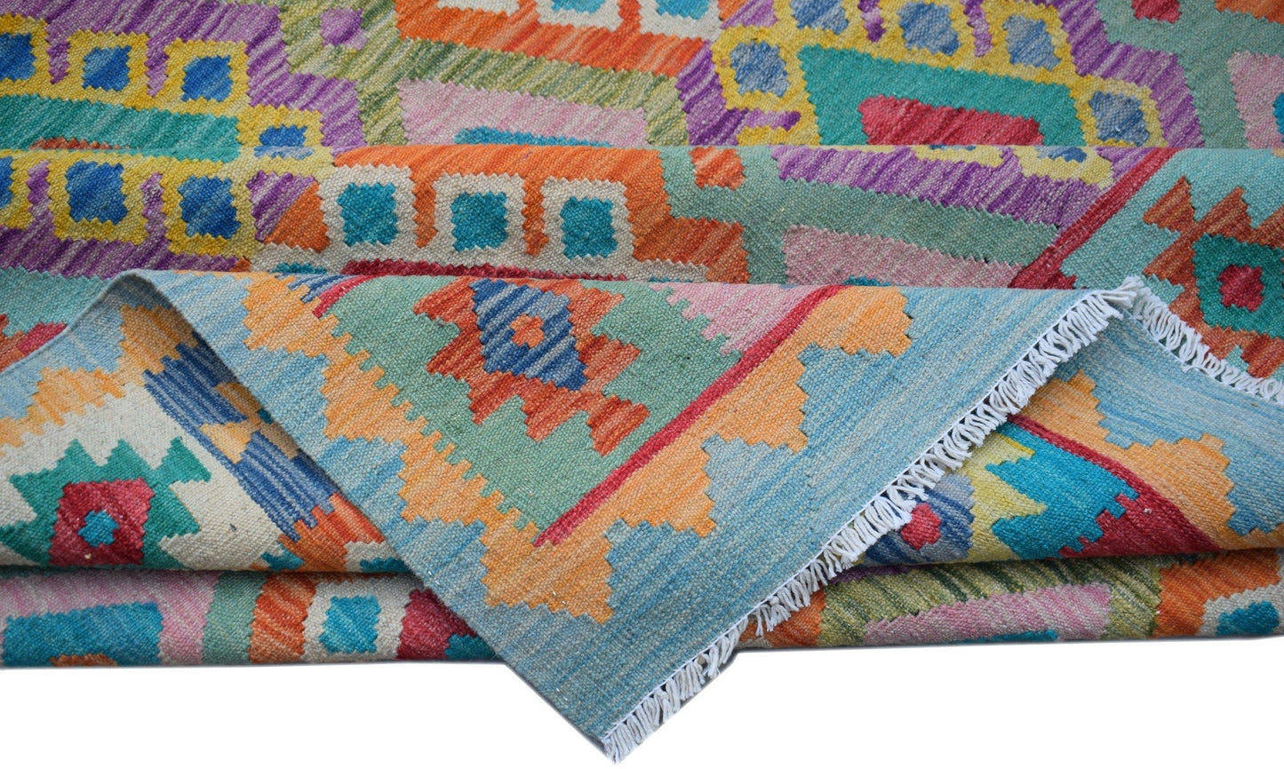 A handwoven Afghan Maimana kilim rug featuring vibrant geometric patterns in wool.