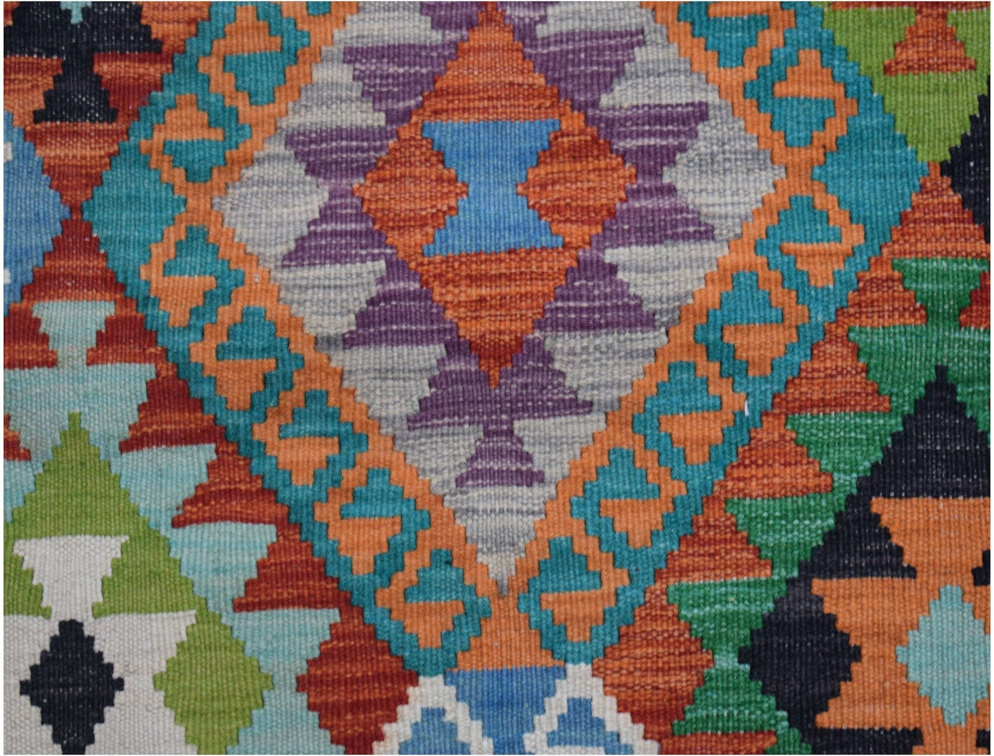 Handwoven Afghan Maimana kilim featuring a vibrant geometric pattern in wool.
