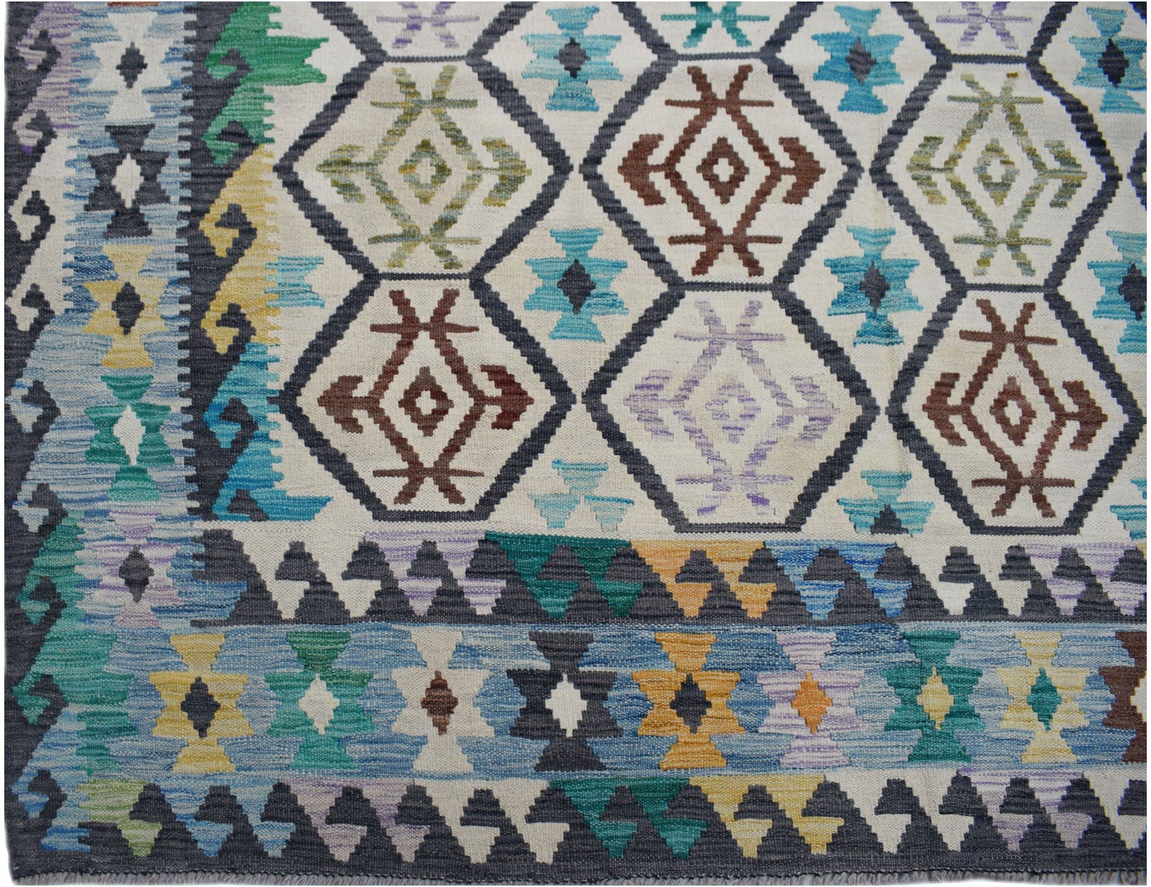Handwoven Afghan Maimana kilim rug featuring a geometric pattern in blue, brown, and yellow tones.