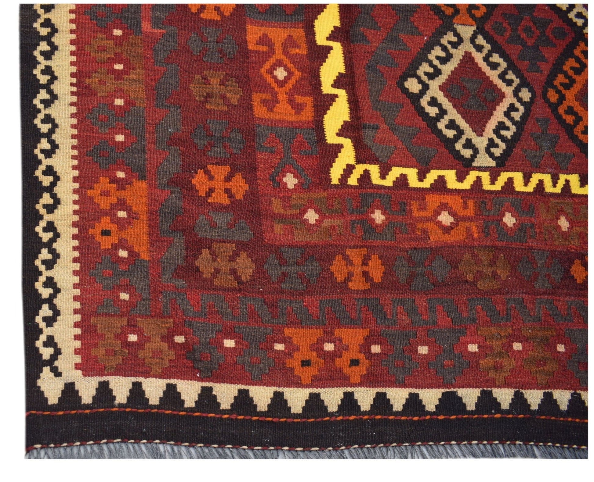 Handwoven Afghan Maimana kilim rug featuring geometric patterns in red, orange, and yellow.