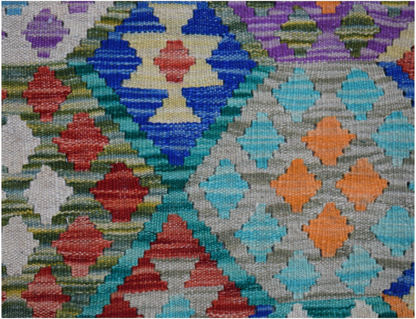Handwoven Afghan Maimana kilim featuring a vibrant geometric diamond pattern in wool.
