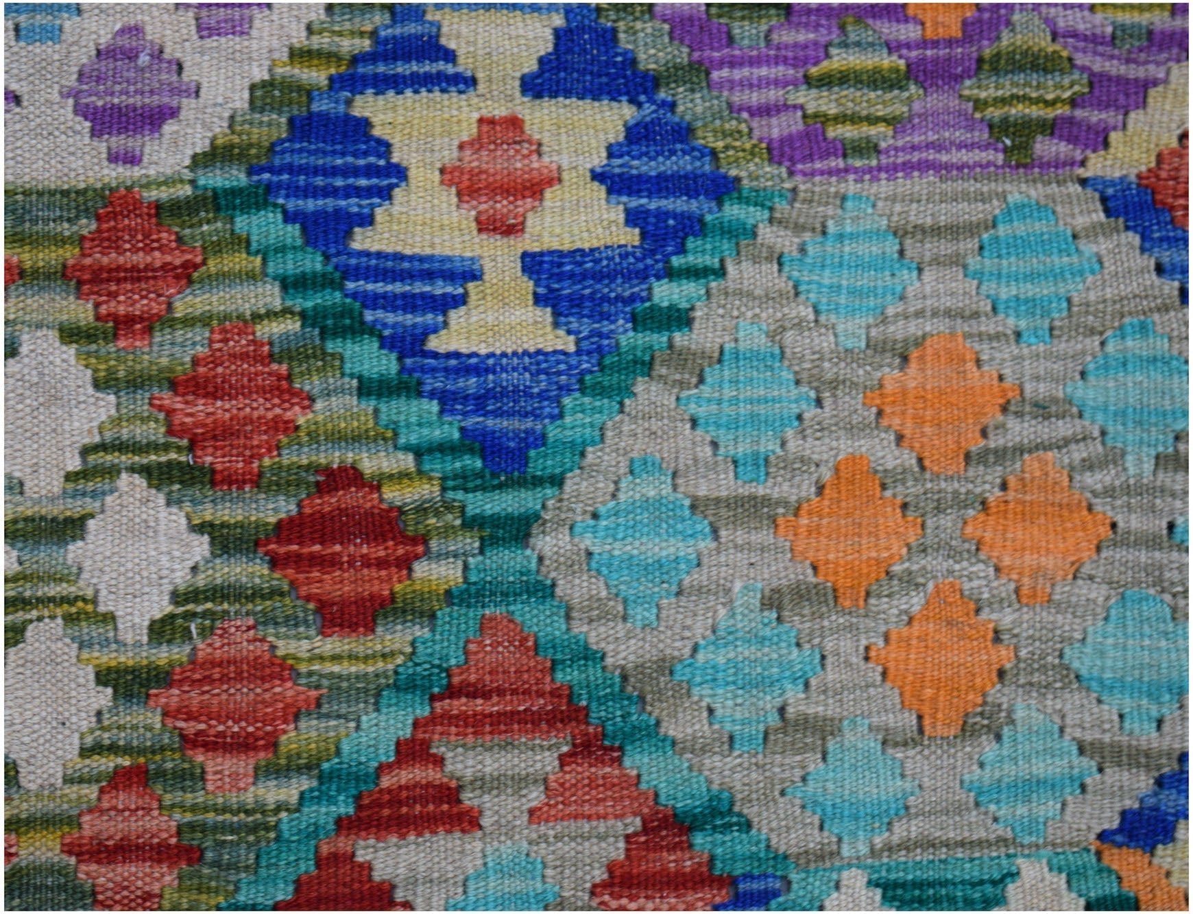 Handwoven Afghan Maimana kilim featuring a vibrant geometric diamond pattern in wool.