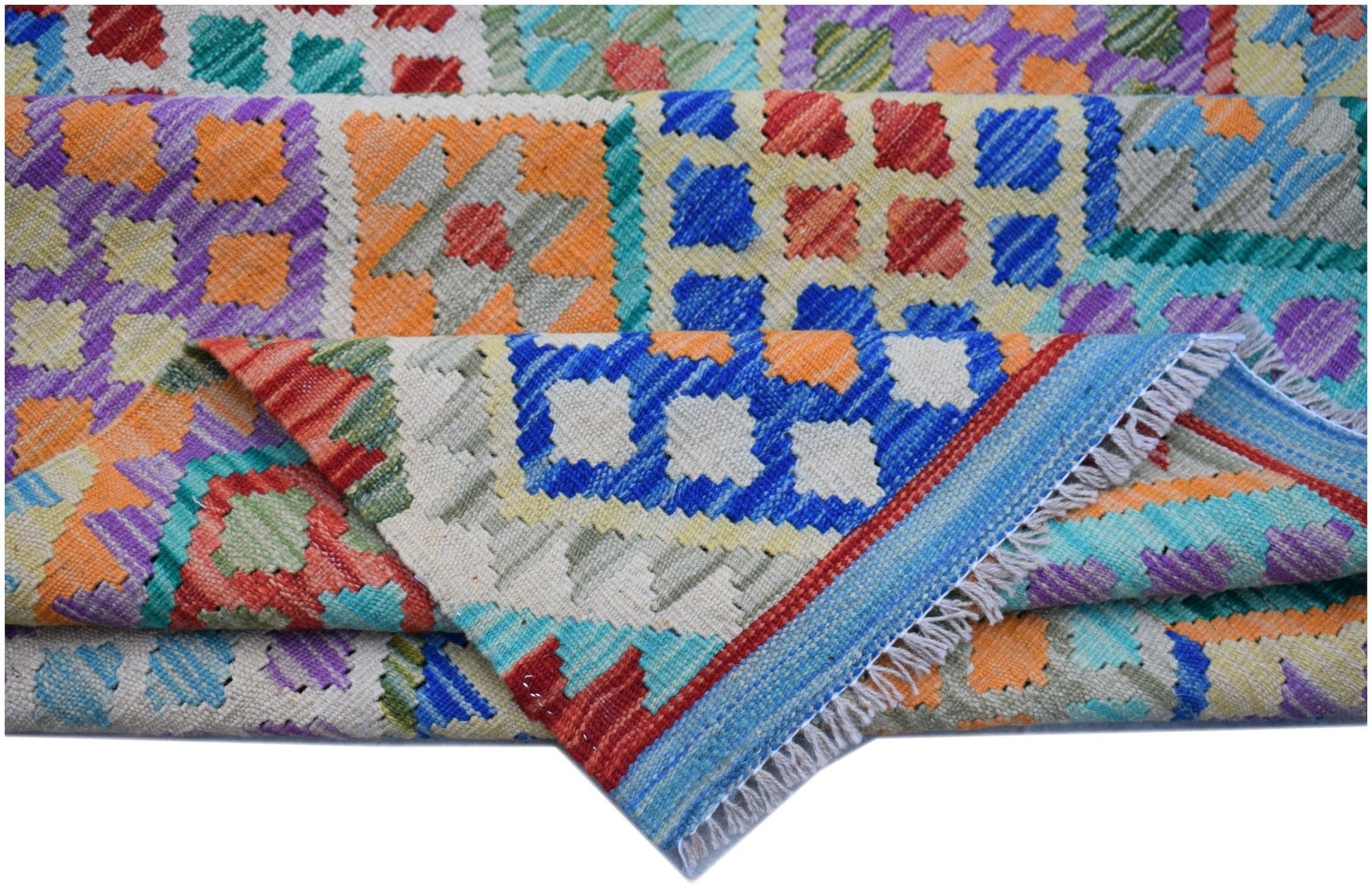 A handmade Afghan Maimana kilim rug featuring a vibrant, geometric patchwork pattern in wool.