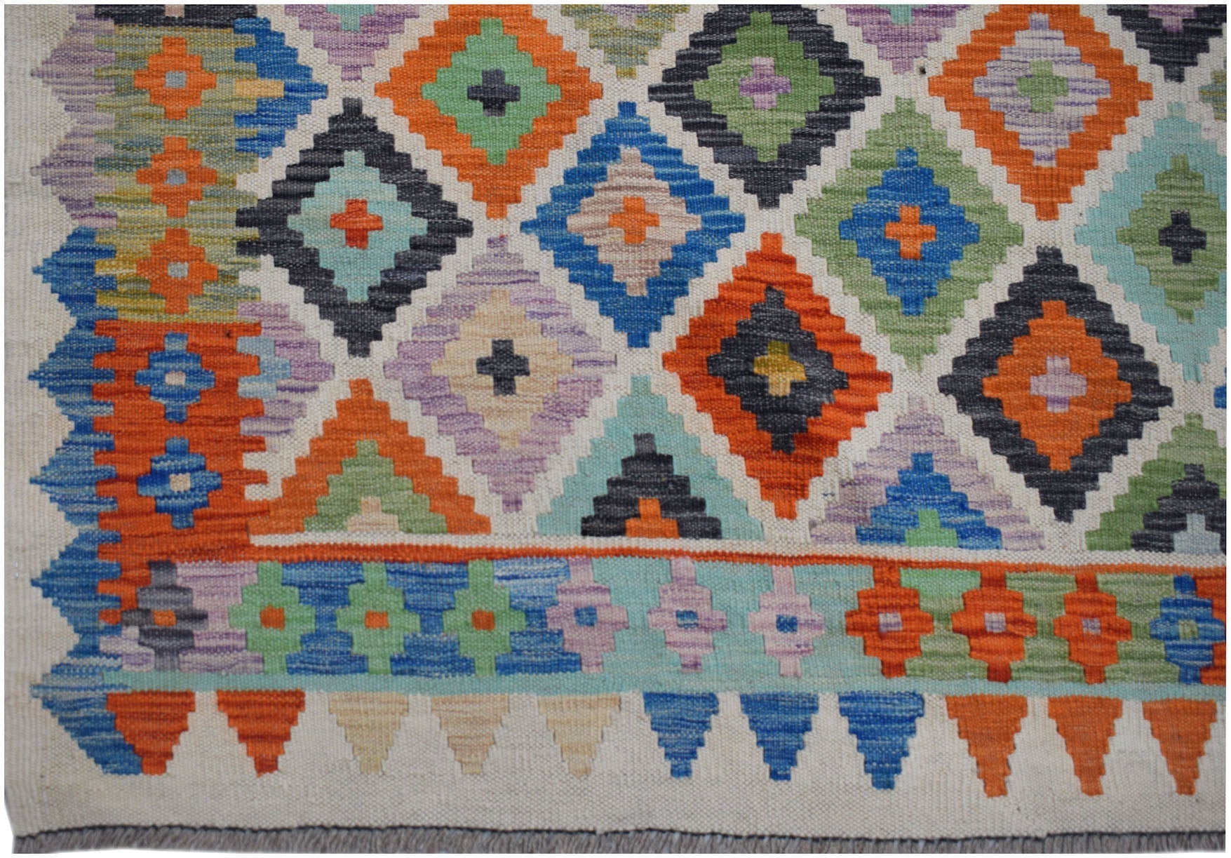 Handwoven Afghan Maimana kilim rug featuring a colorful geometric diamond pattern in wool.