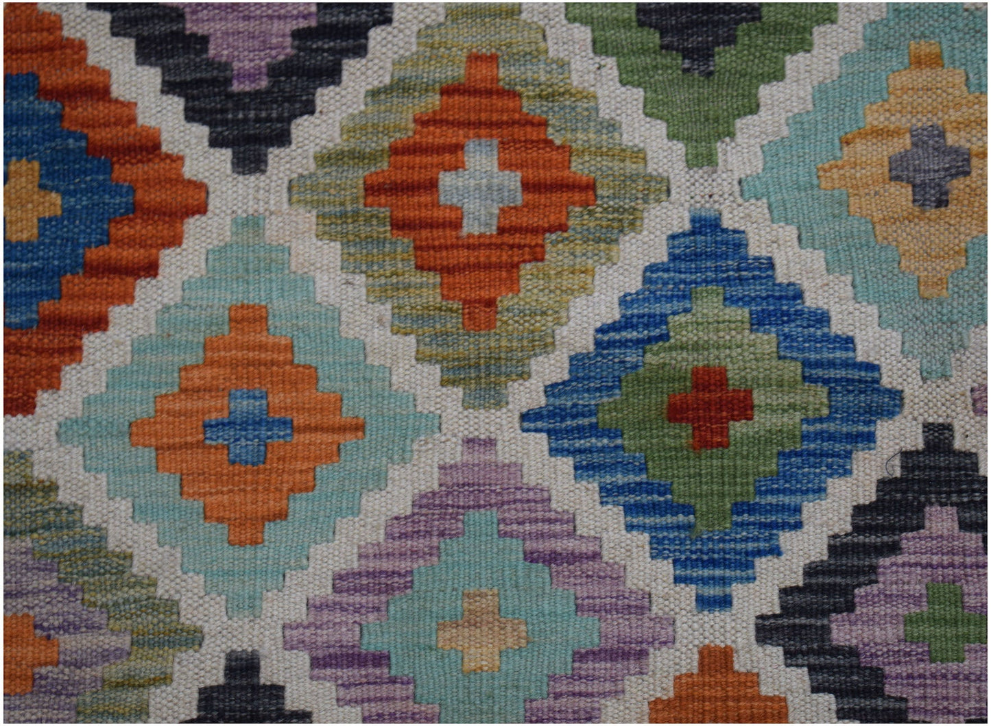 Handwoven Afghan Maimana kilim rug featuring a colorful geometric diamond pattern in wool.