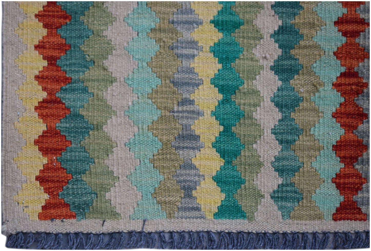 Handwoven Afghan Maimana kilim rug featuring a colorful geometric pattern and fringed edges.