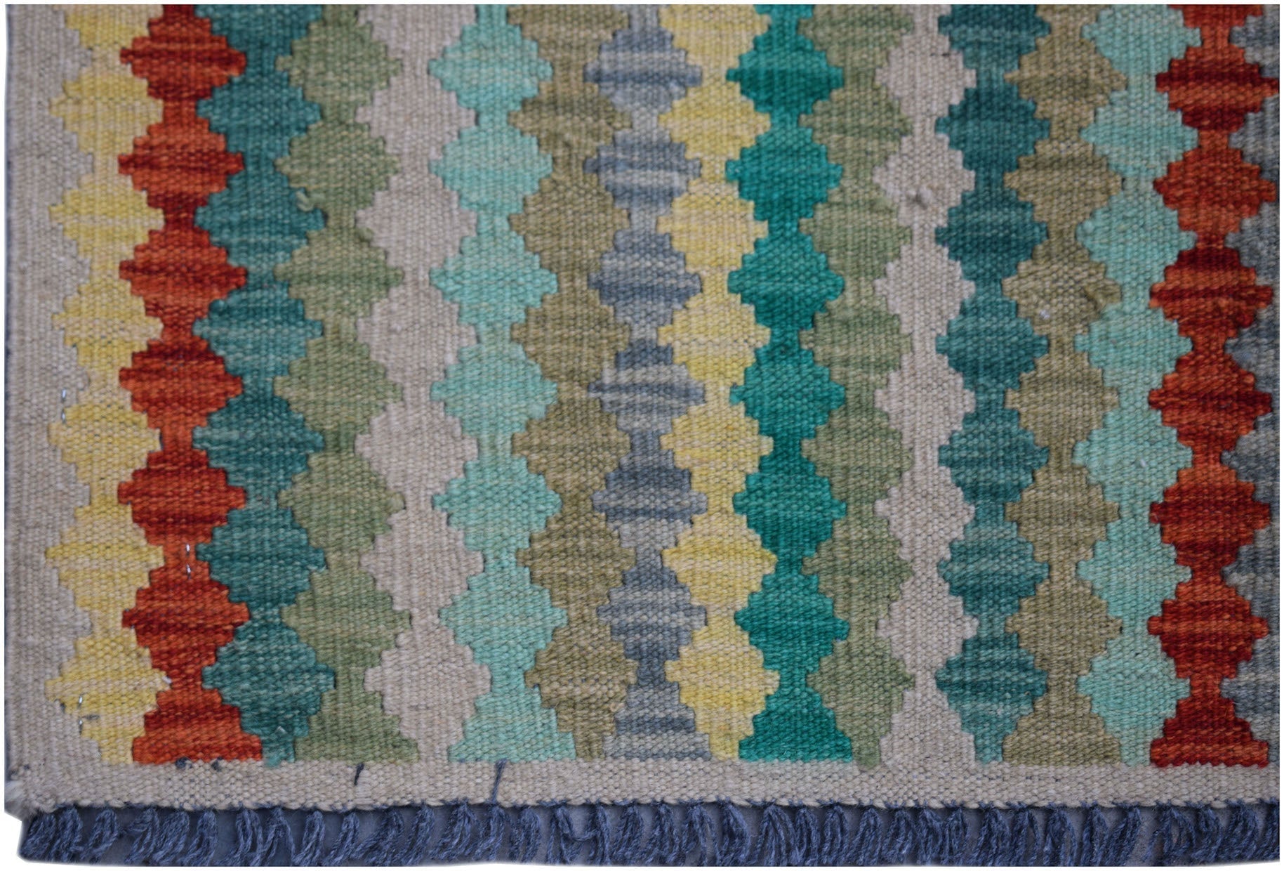 Handwoven Afghan Maimana kilim rug featuring a colorful geometric pattern and fringed edges.