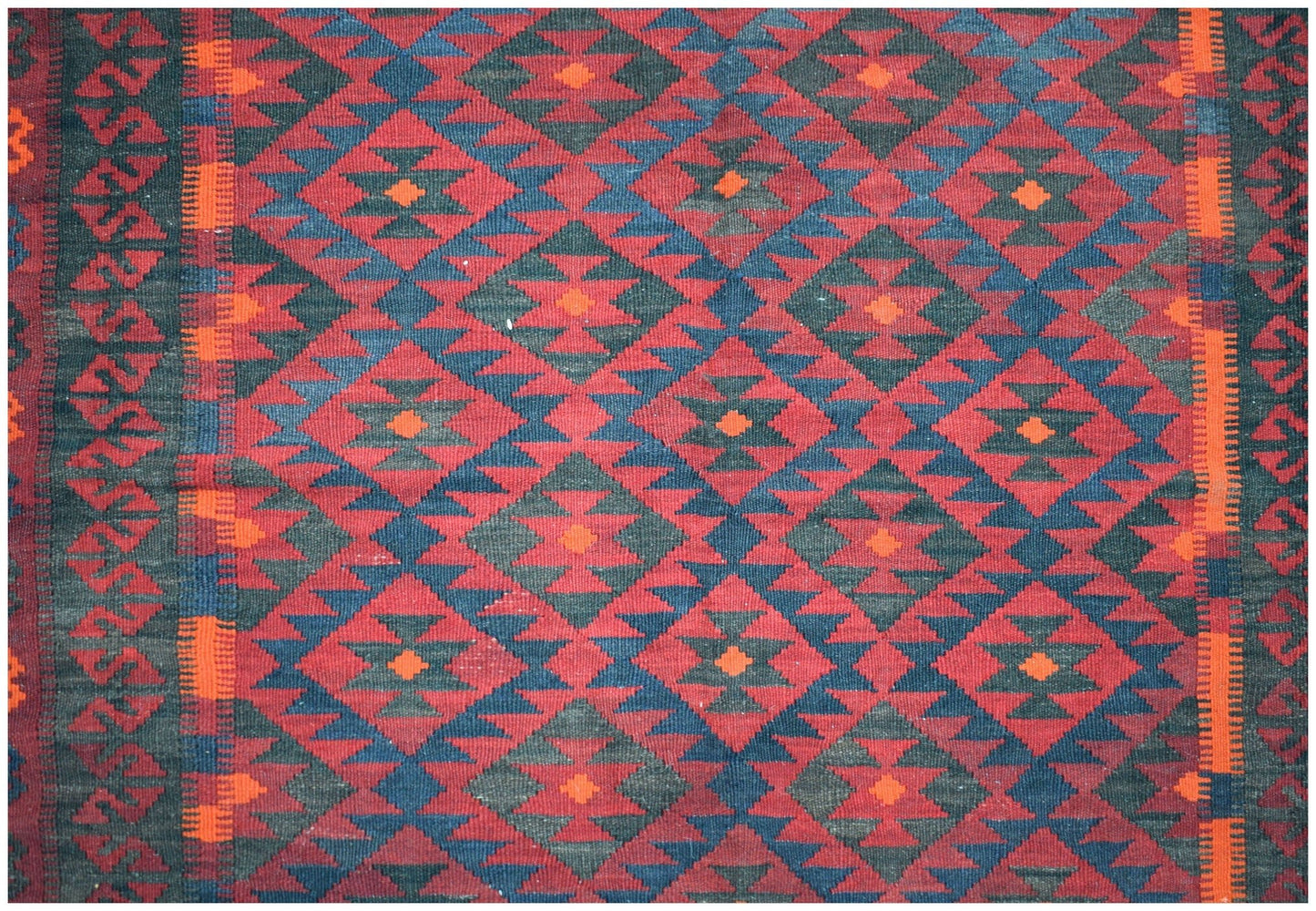 Handwoven Afghan Maimana kilim featuring a repeating geometric diamond pattern in red and blue.