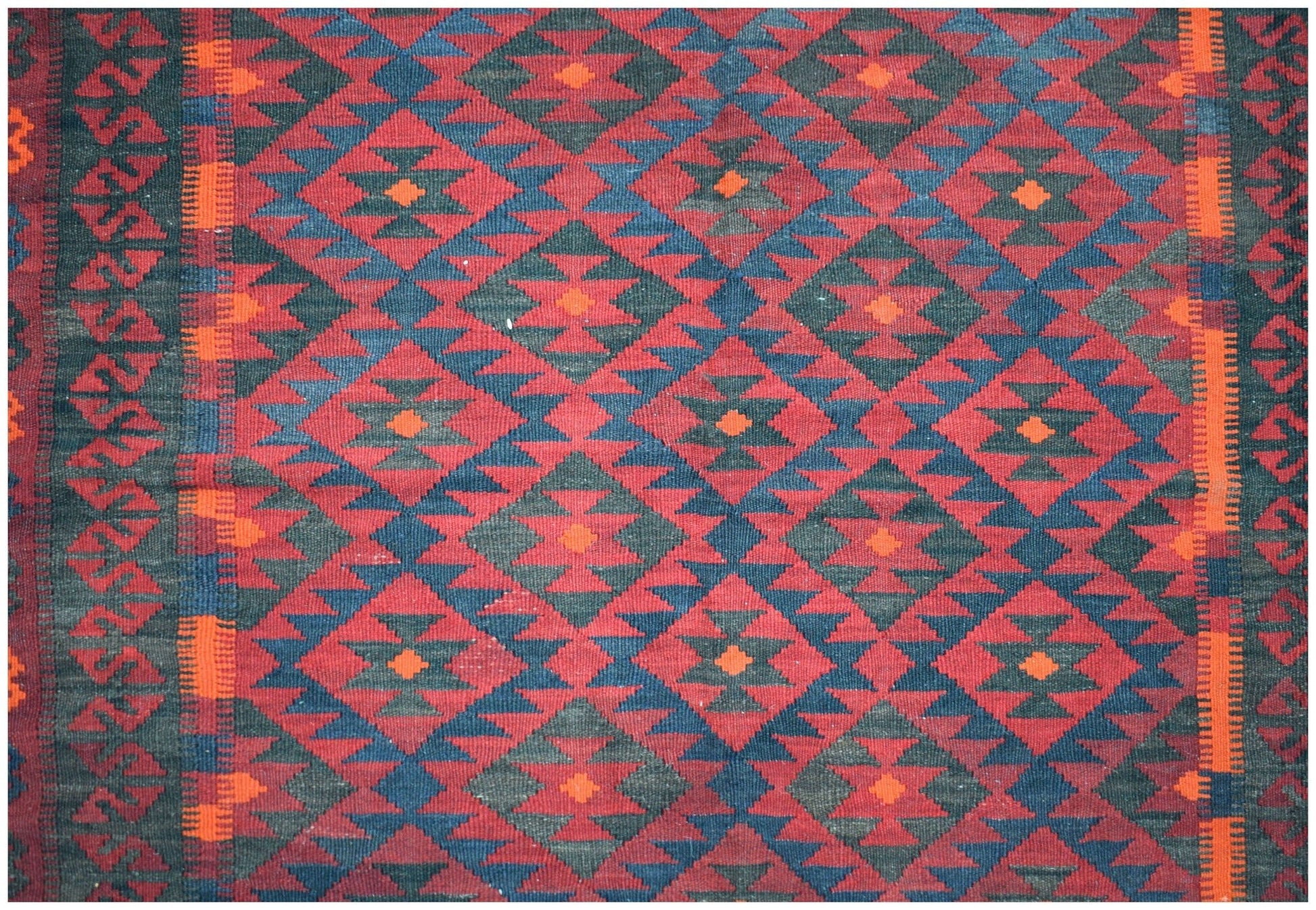 Handwoven Afghan Maimana kilim featuring a repeating geometric diamond pattern in red and blue.