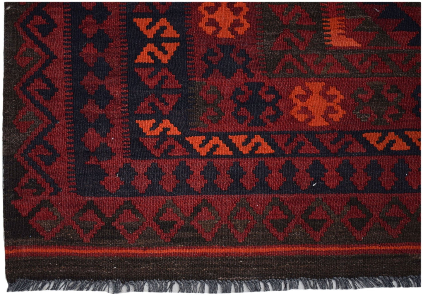 Handwoven Afghan Maimana kilim rug featuring geometric patterns in red, orange, and dark brown.