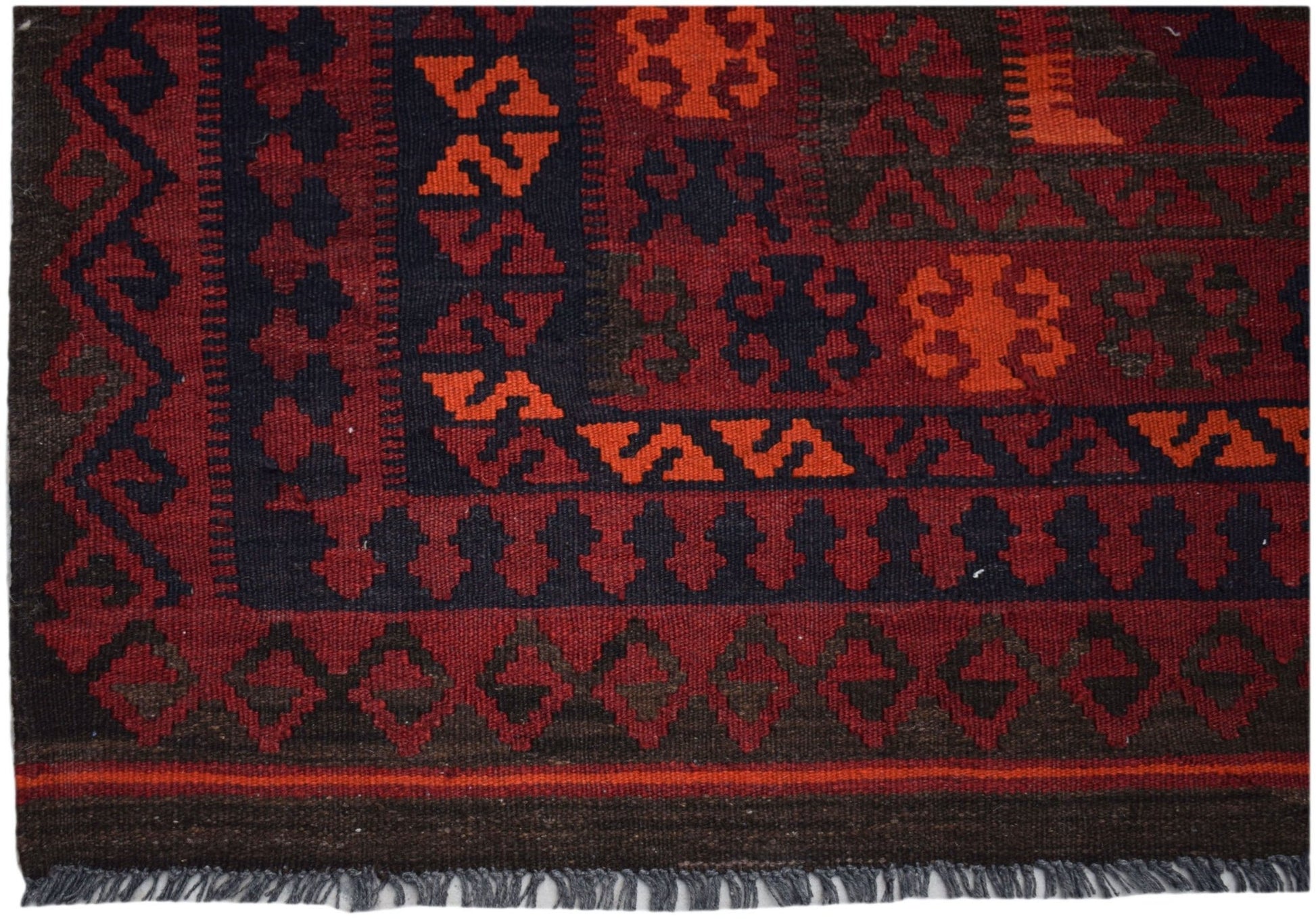 Handwoven Afghan Maimana kilim rug featuring geometric patterns in red, orange, and dark brown.