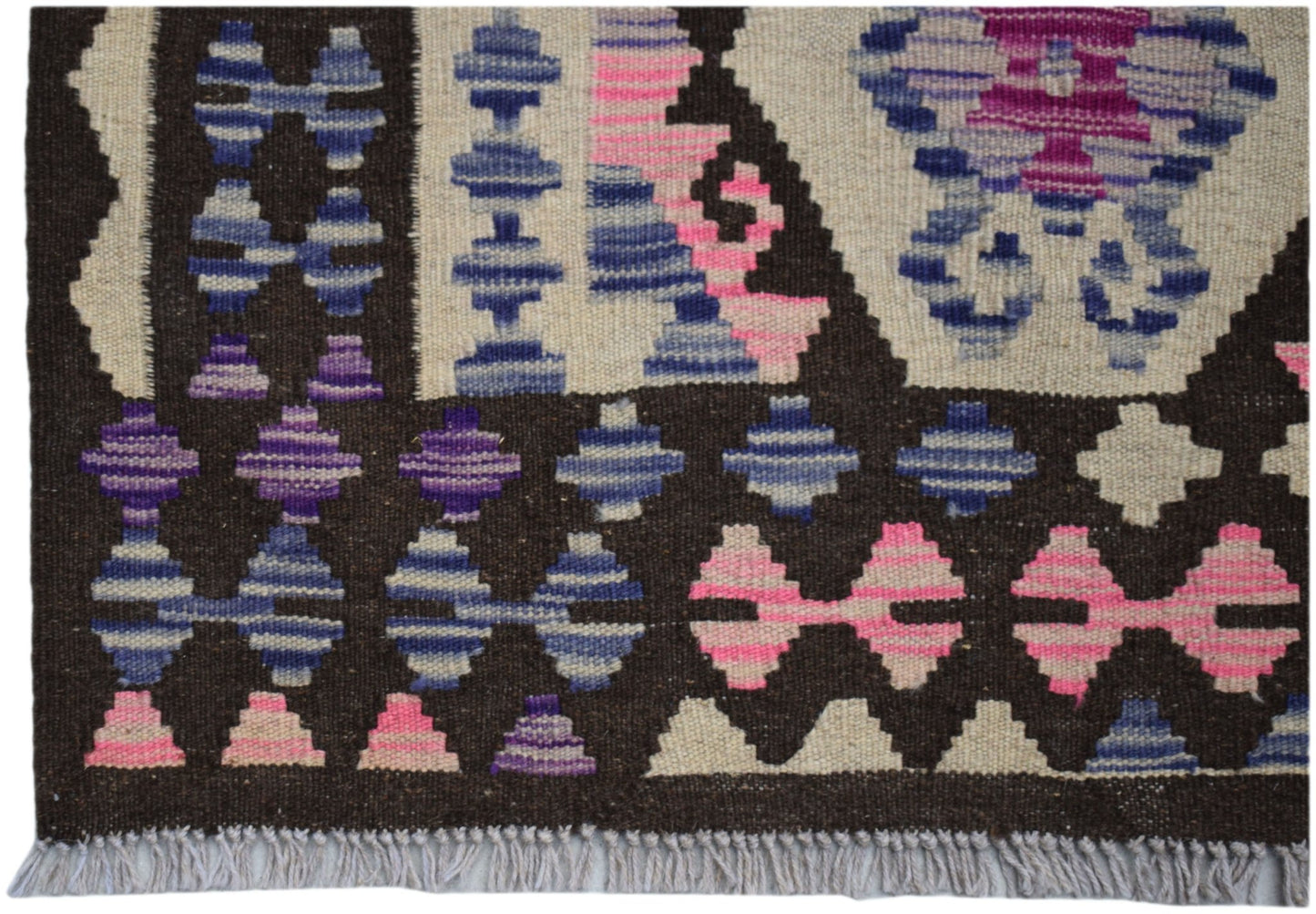 Handwoven Afghan Maimana kilim rug featuring geometric patterns in blue, pink, and purple wool.