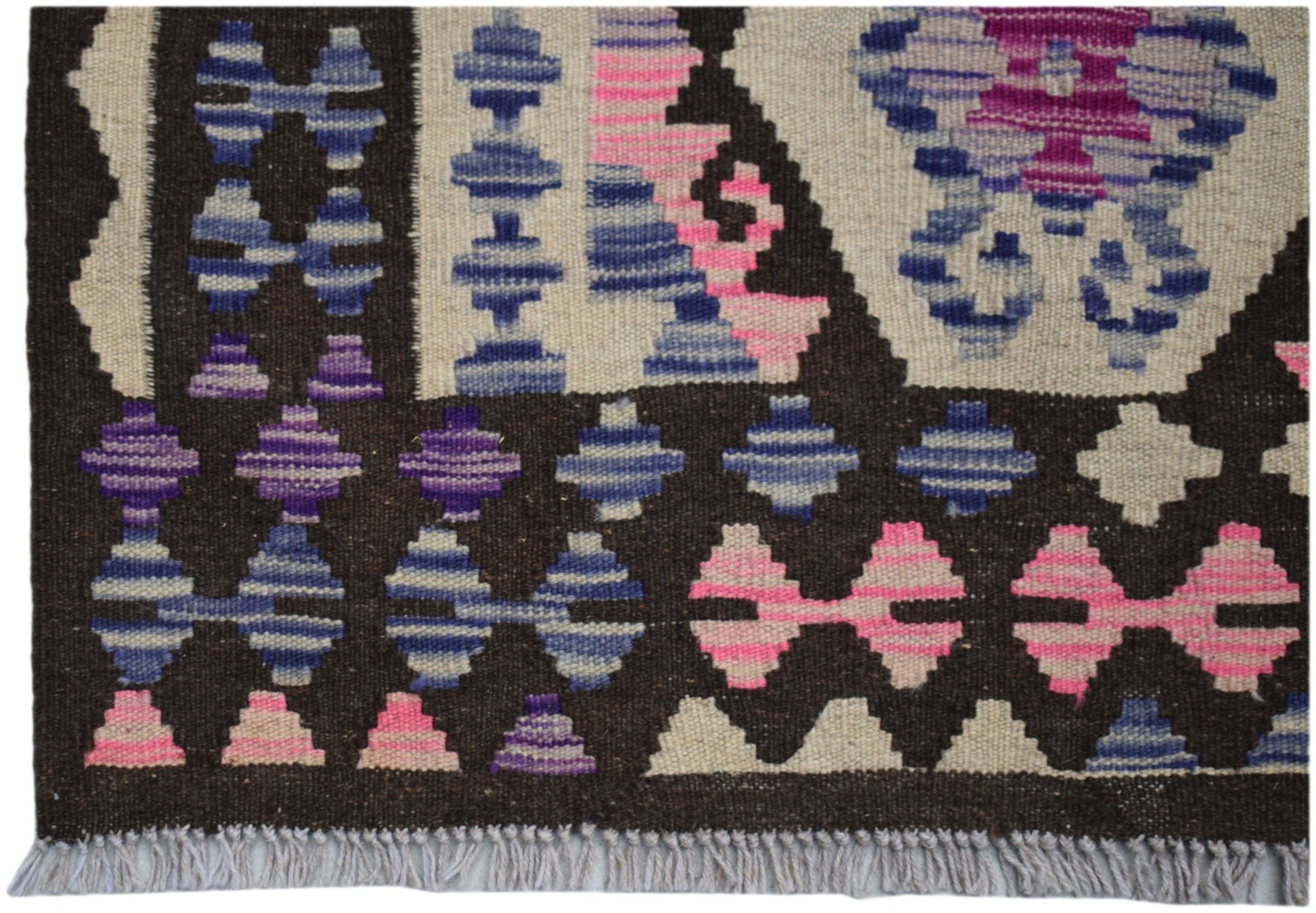 Handwoven Afghan Maimana kilim rug featuring geometric patterns in blue, pink, and purple wool.