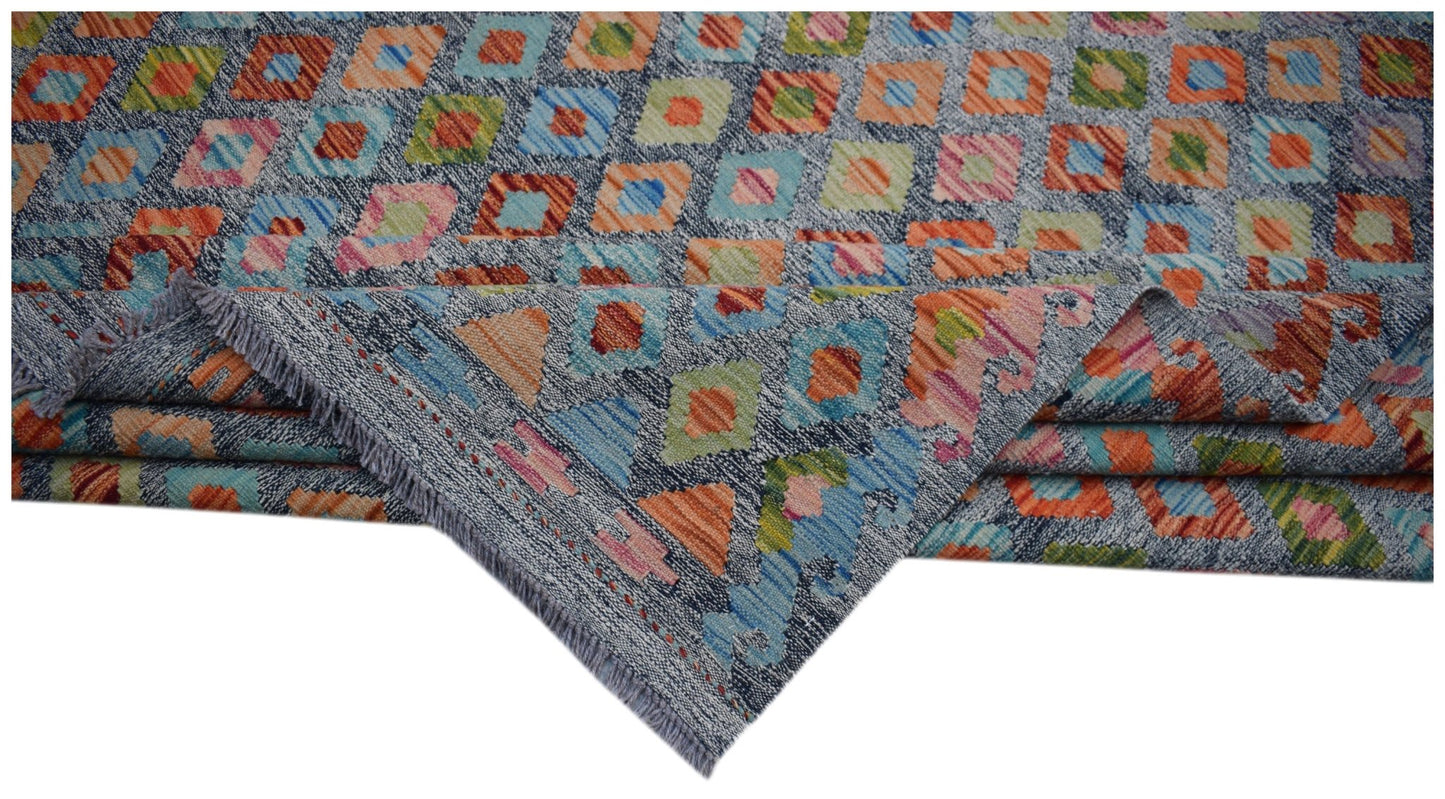 A handmade Afghan Maimana kilim rug featuring a colorful geometric diamond pattern on a grey base.