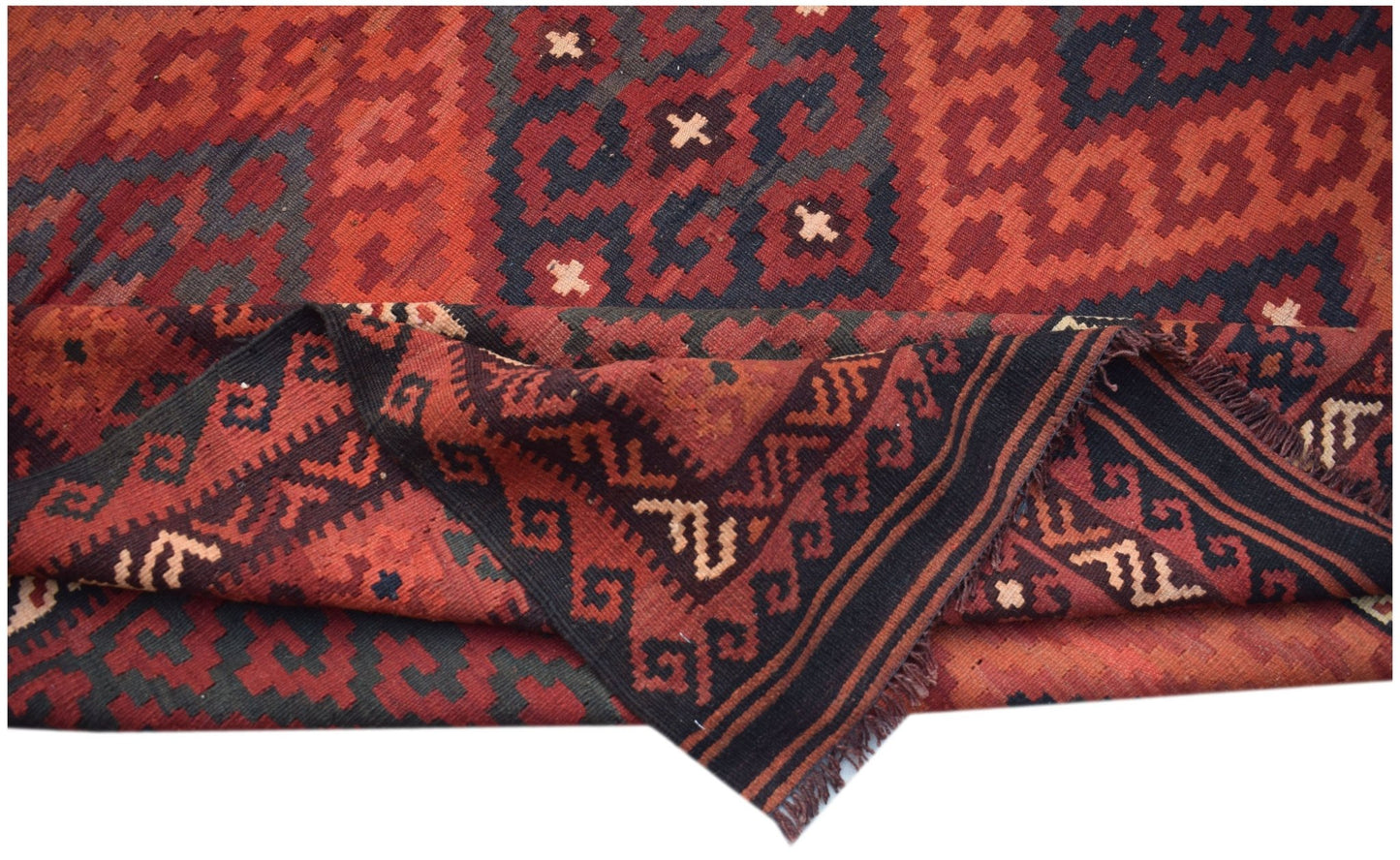 Handwoven Afghan Maimana kilim rug featuring geometric patterns in red and black wool.