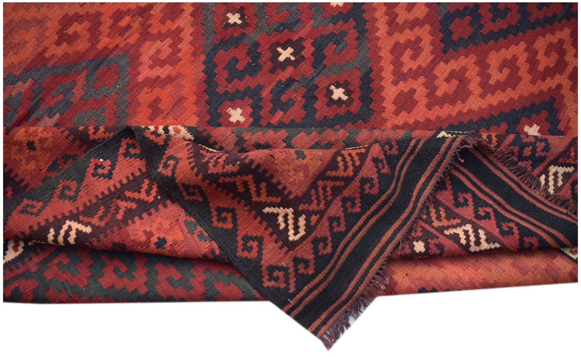 Handwoven Afghan Maimana kilim rug featuring geometric patterns in red and black wool.