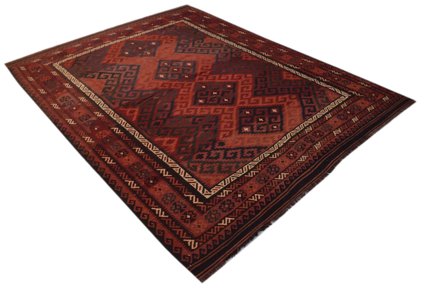 Handwoven Afghan Maimana kilim rug featuring a geometric pattern in shades of red and dark blue.