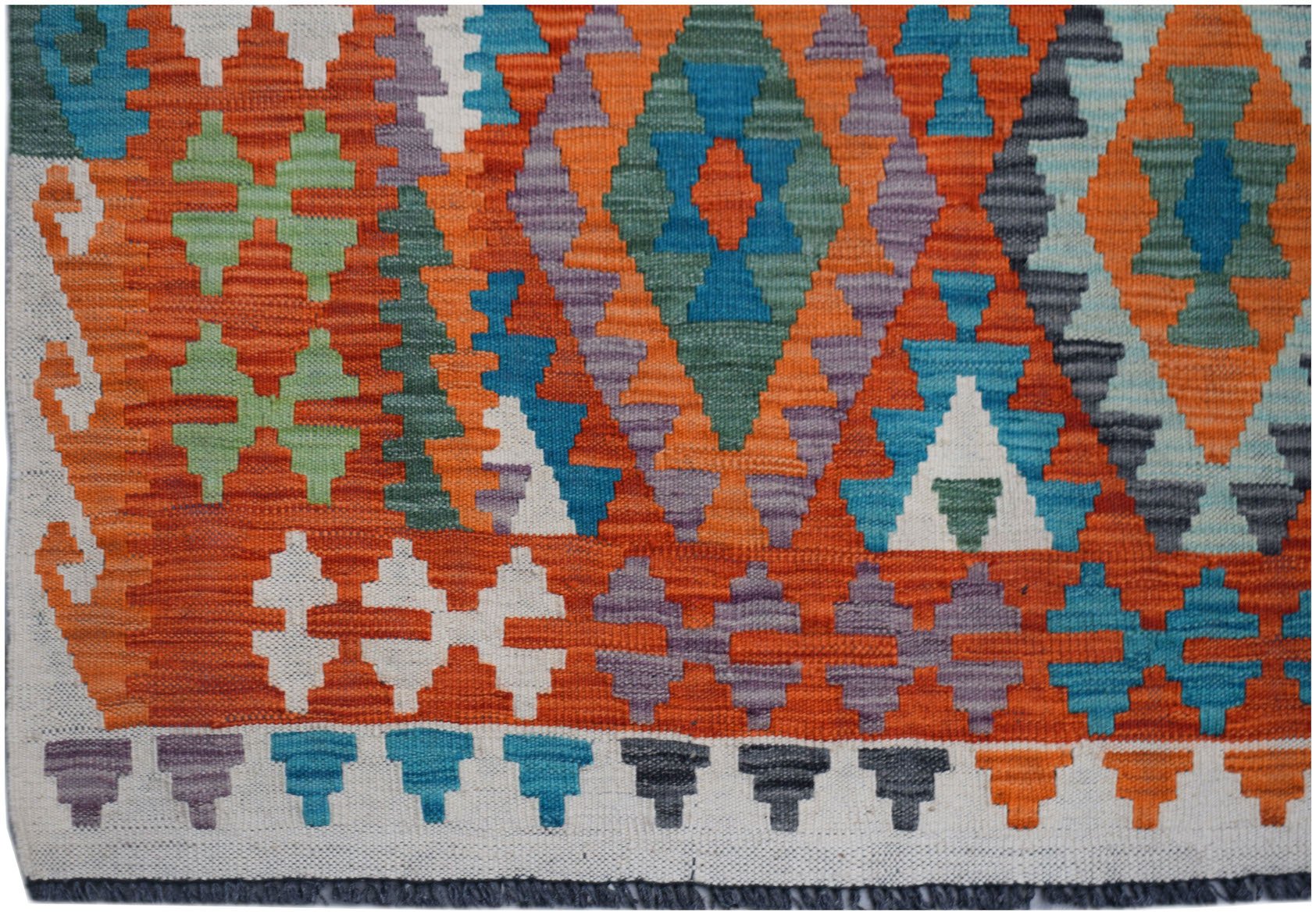 Handwoven Afghan Maimana kilim featuring a vibrant geometric pattern in wool.
