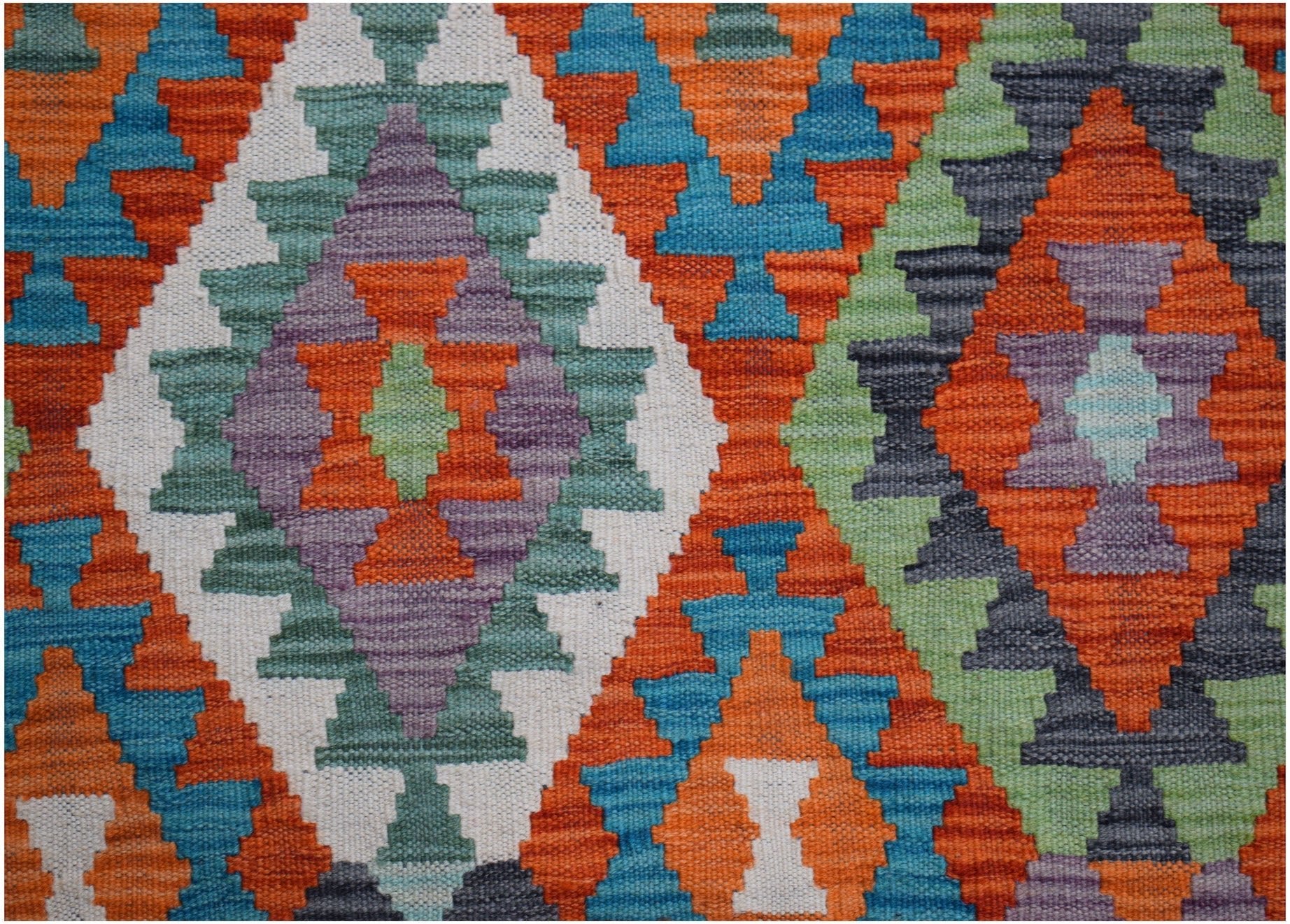Handwoven Afghan Maimana kilim rug featuring a vibrant geometric diamond pattern in wool.