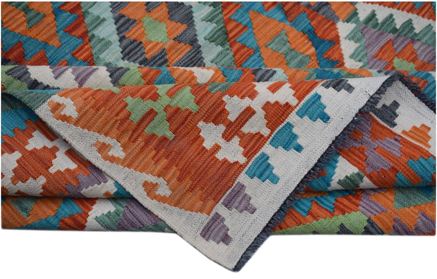 A handwoven Afghan Maimana kilim rug featuring a vibrant geometric pattern in wool.