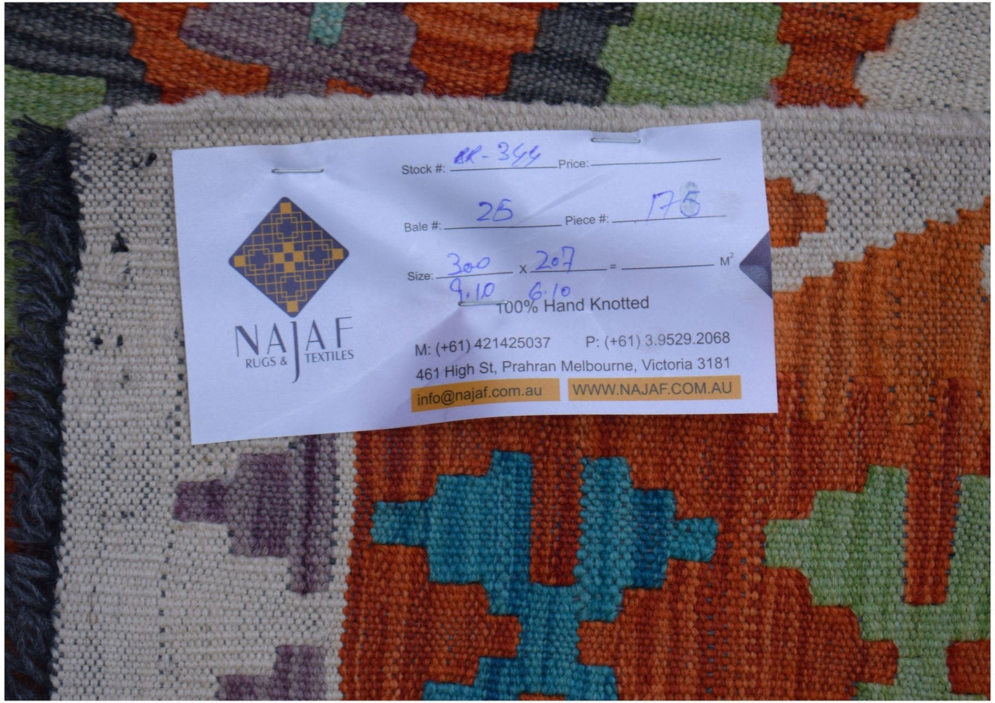 An Afghan Maimana kilim rug featuring a vibrant geometric pattern in orange, blue, and green.