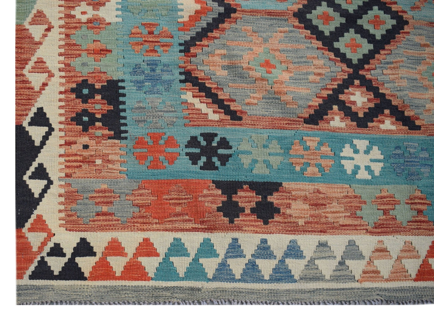 Handwoven Afghan Maimana kilim rug featuring a geometric pattern in blue, red, and cream tones.