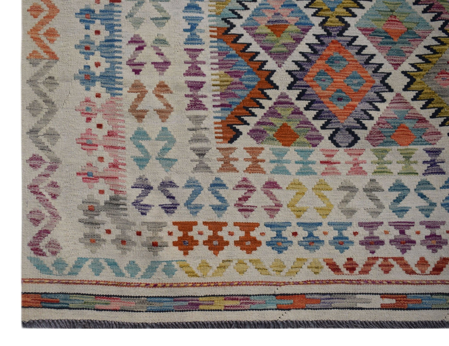 Handwoven Afghan Maimana kilim rug featuring a colorful geometric pattern on a cream background.