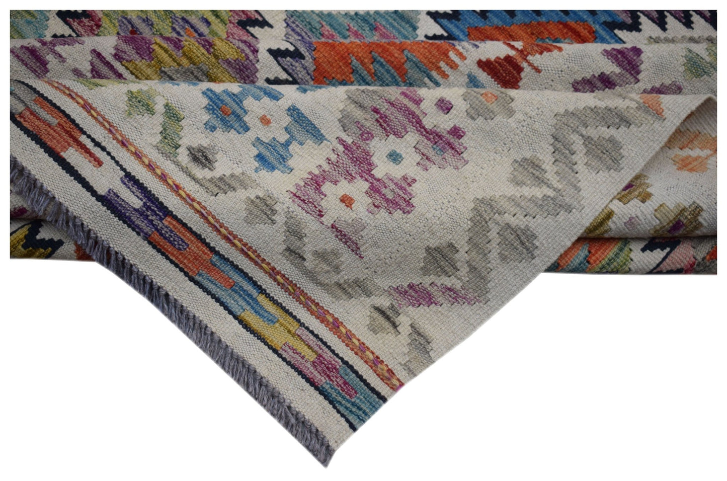 A handwoven Afghan Maimana kilim rug featuring colorful geometric patterns on a cream background.