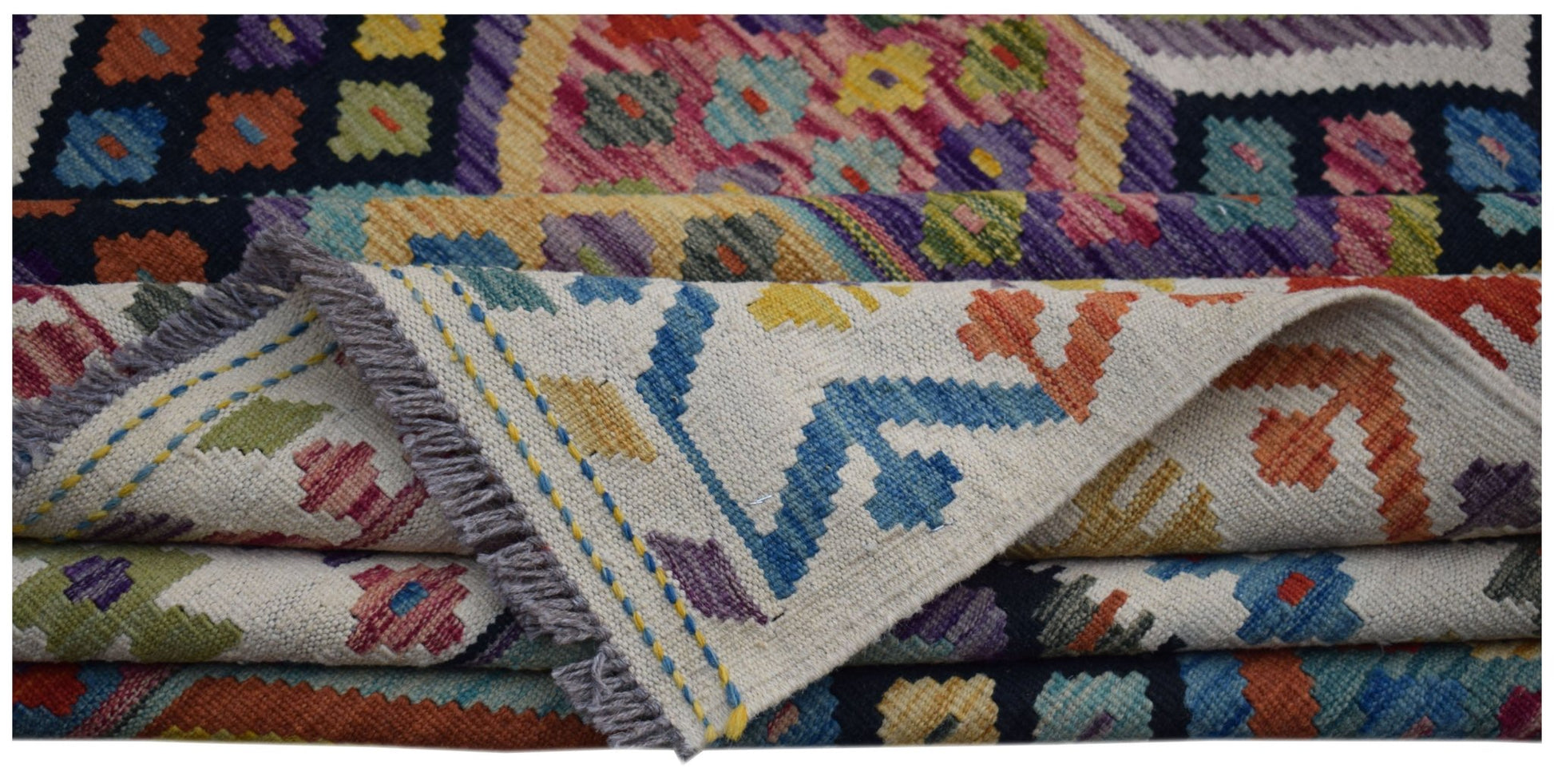 A handwoven Afghan Maimana kilim rug featuring colorful geometric patterns on a flat wool weave.