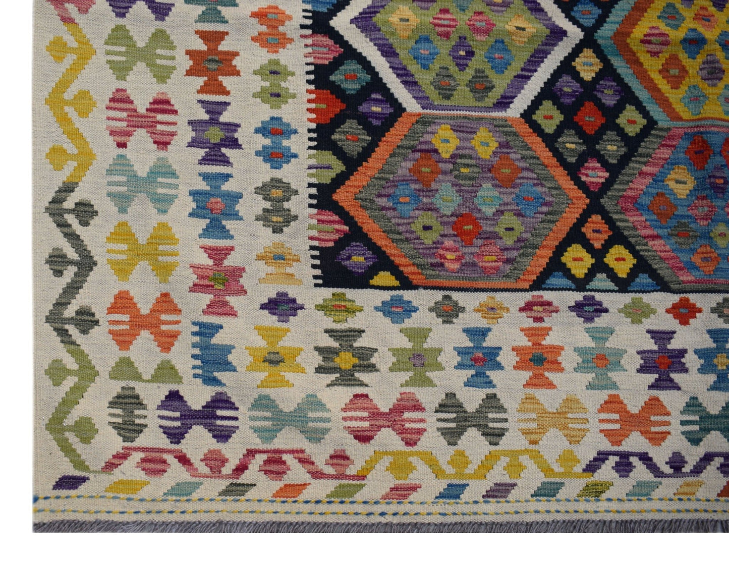 Handwoven Afghan Maimana kilim featuring a colorful geometric pattern on a cream background.