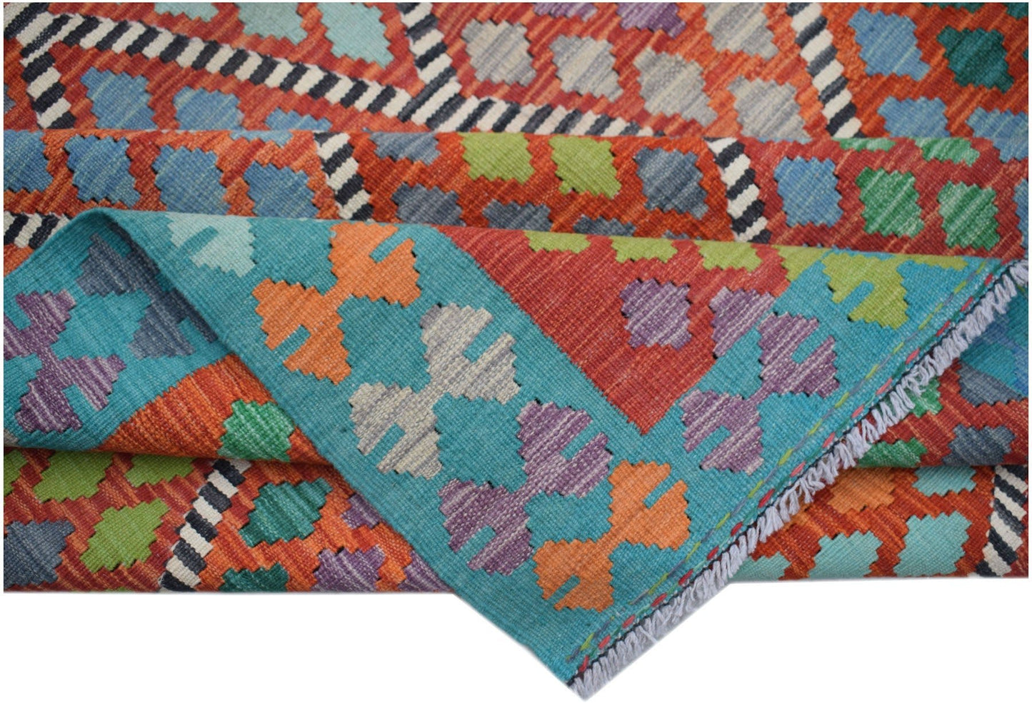 A handwoven Afghan Maimana kilim rug featuring a vibrant geometric pattern in wool.