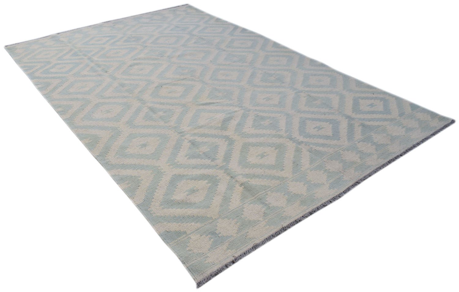 A handmade Afghan Maimana kilim rug featuring a light blue and cream geometric diamond pattern.