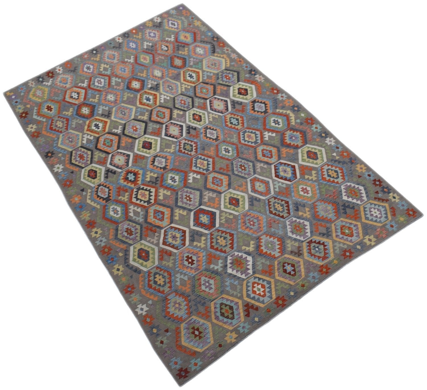 A rectangular handmade Afghan Maimana kilim rug featuring a colorful geometric hexagon pattern.