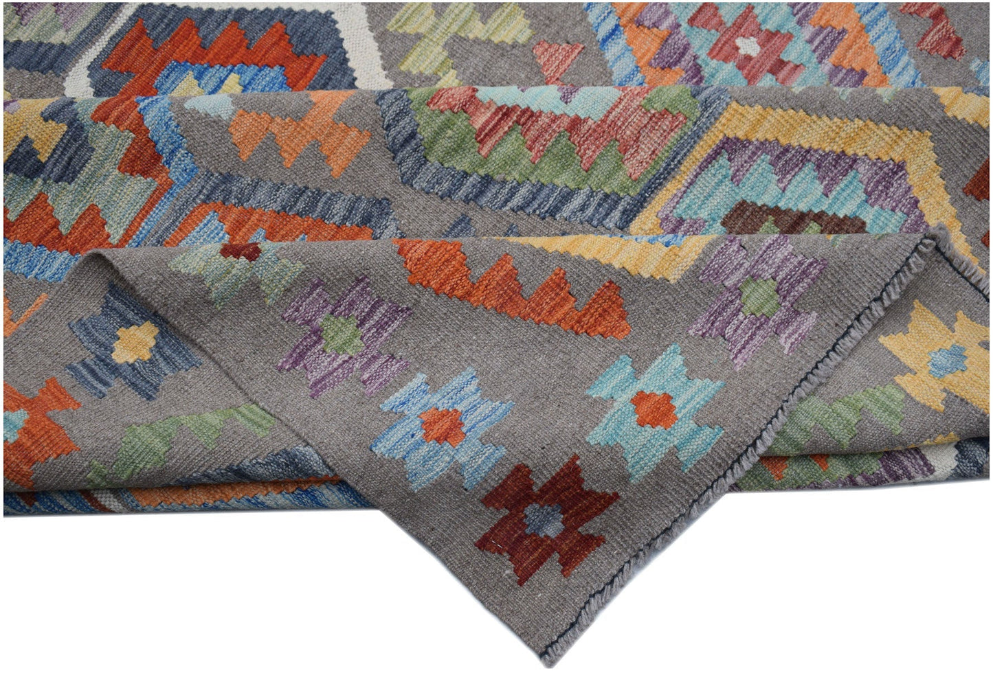 A handmade Afghan Maimana kilim rug featuring a grey background with colorful geometric patterns.